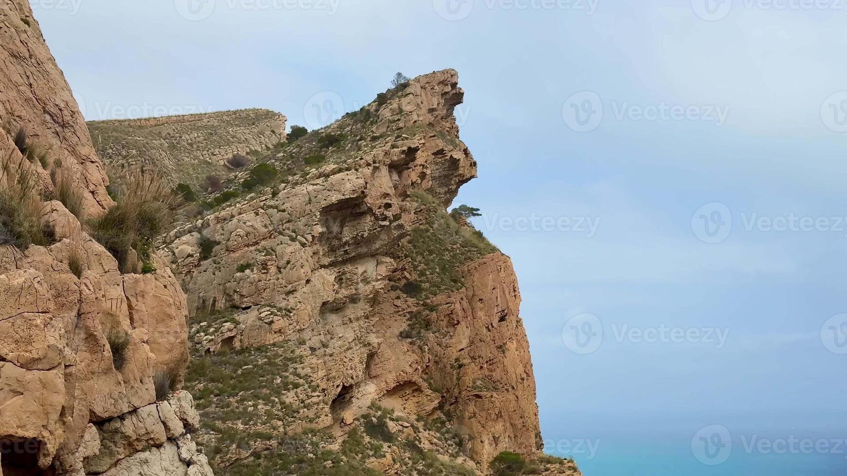 The breathtaking cliffs, adorned with lush greenery, provide stunning views of the vibrant blue ocean below photo