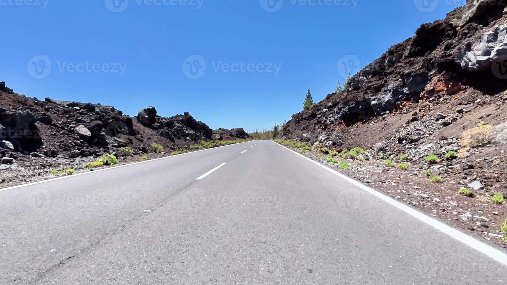 A beautiful and picturesque highway that is surrounded by stunning lava rock landscapes and clear blue skies photo