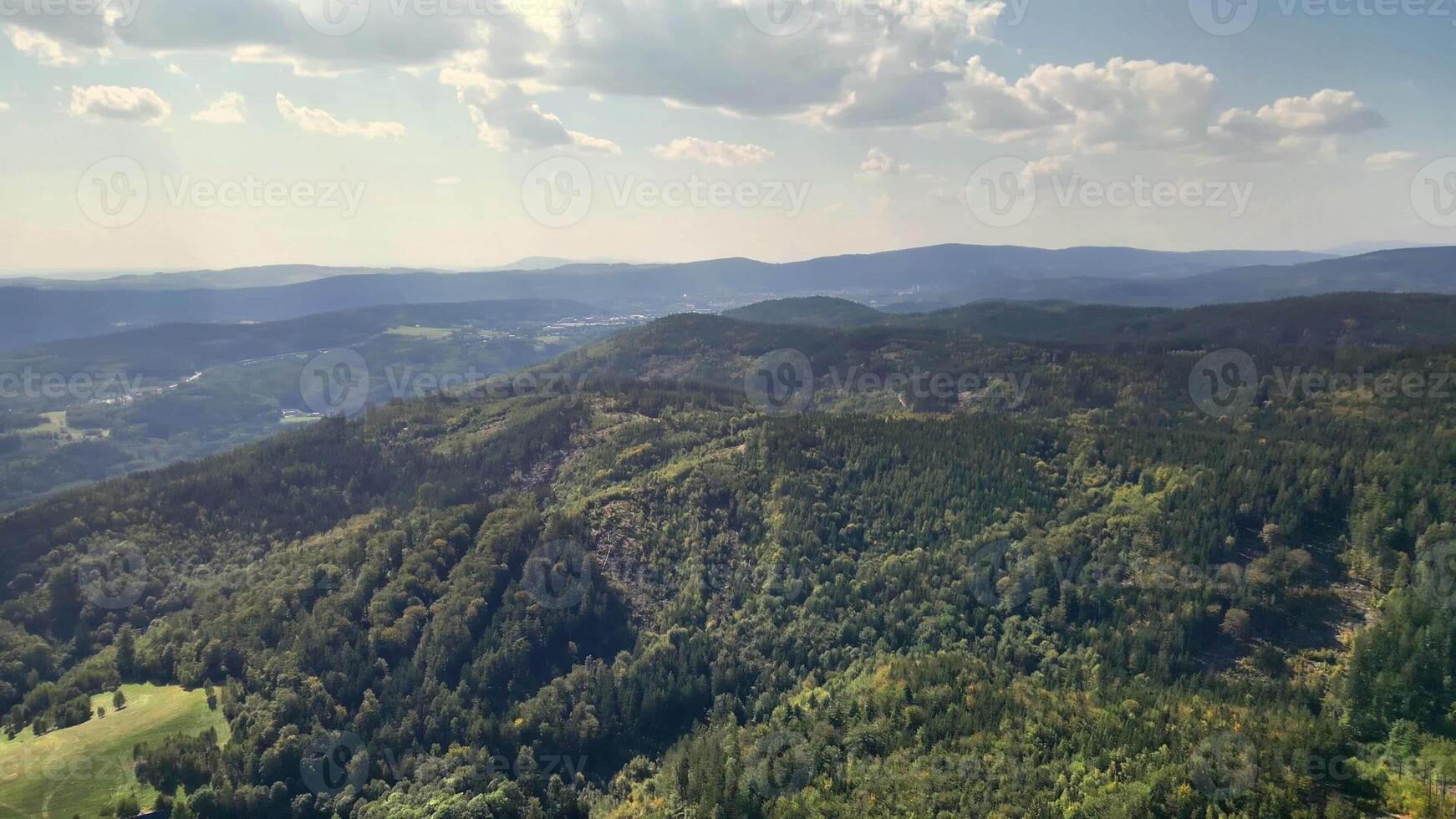 A stunning aerial perspective of verdant mountains and rolling hills, capturing nature's tranquility. photo