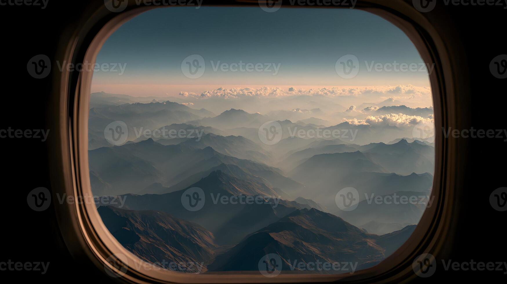 Aerial view of majestic mountains from an airplane window offering a serene landscape experience photo