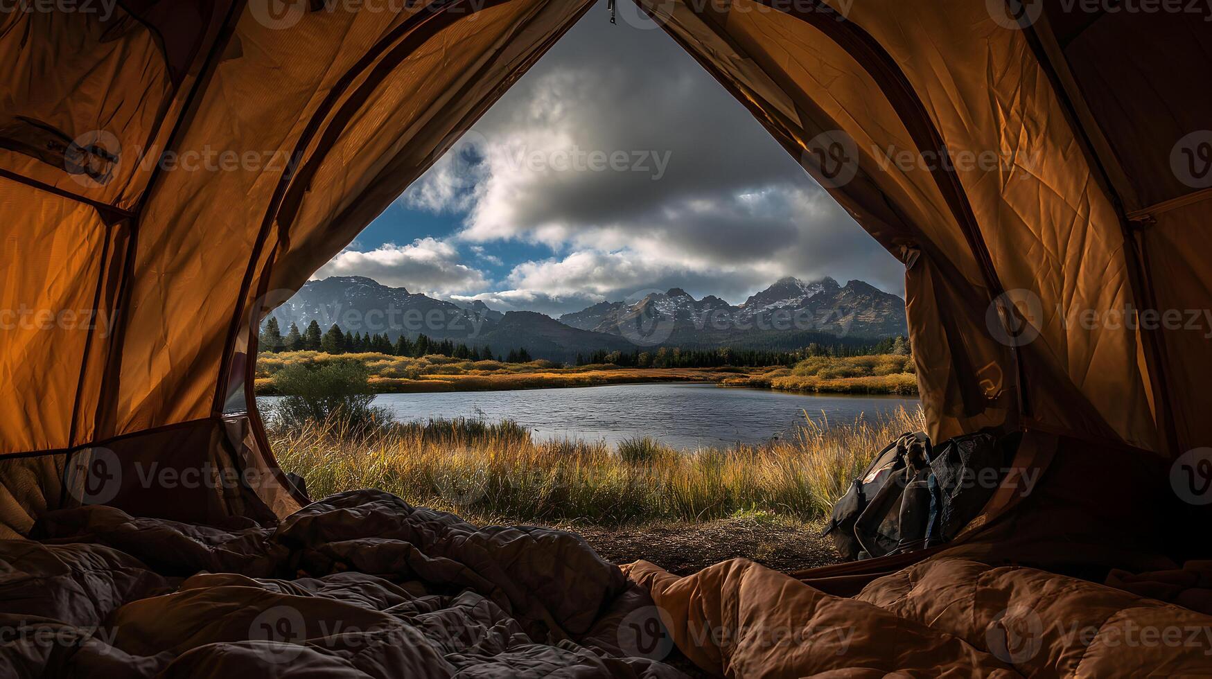 Camping by the lake a peaceful view from inside the tent with the mountains in the distance photo