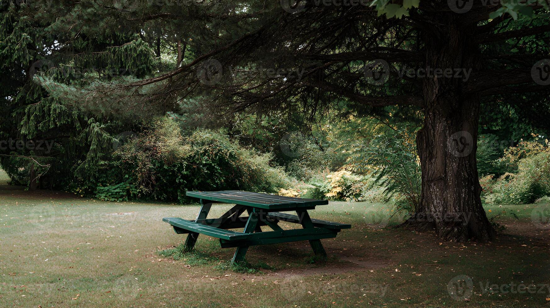 Serene picnic setting with a green table, surrounded by lush trees and a peaceful atmosphere photo
