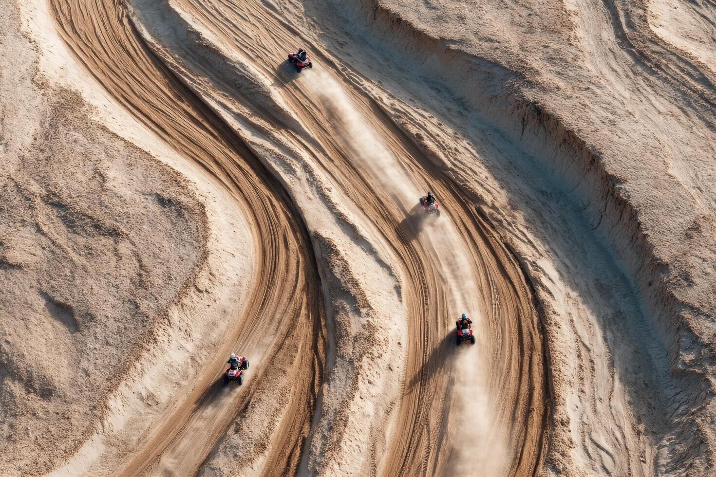 ATVs zoom across winding sandy tracks in a desert area, creating dust clouds as they race under bright daylight photo