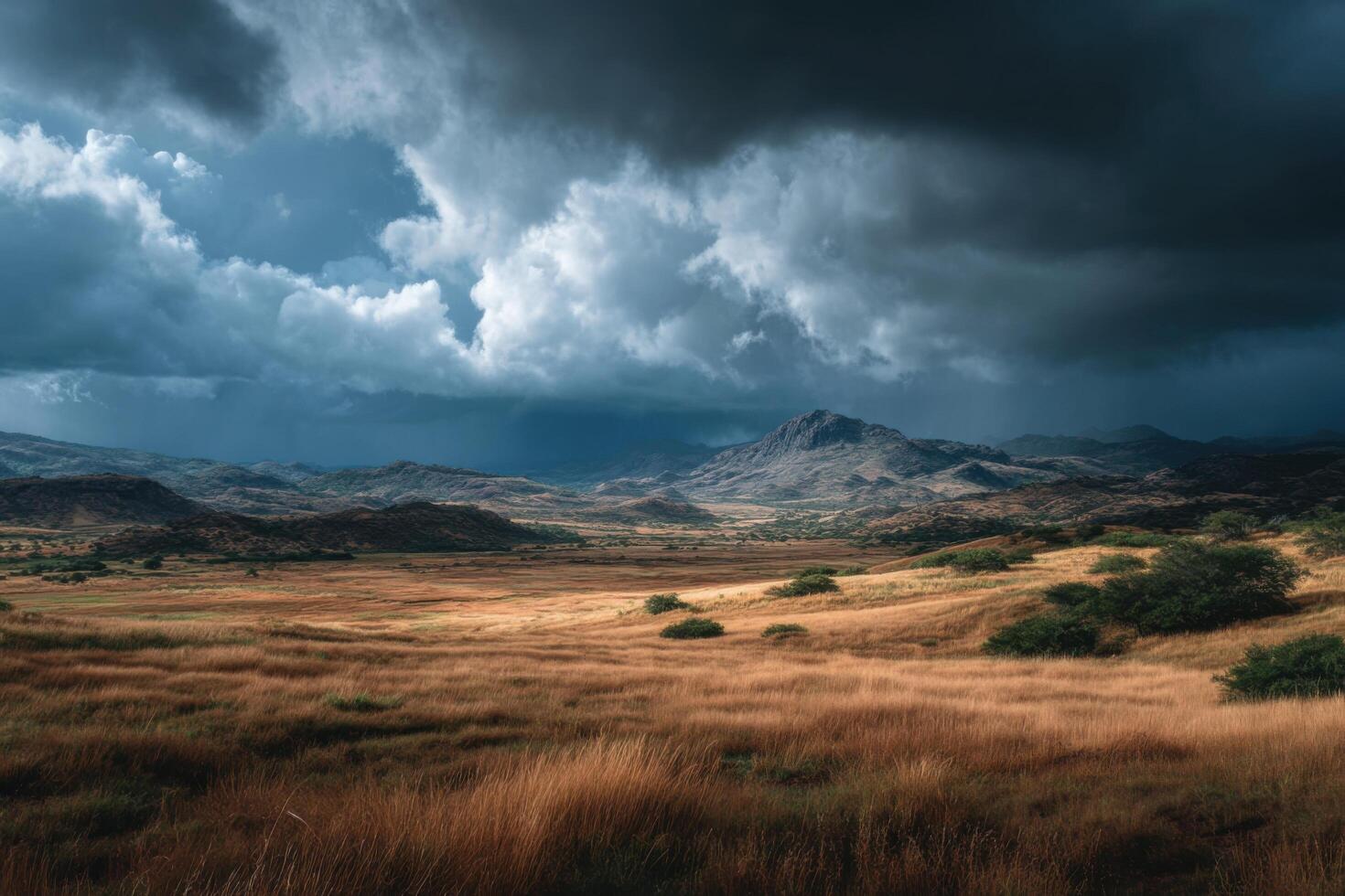Thunderous clouds loom over golden grasslands, creating a dramatic contrast in the mountainous terrain during the afternoon photo