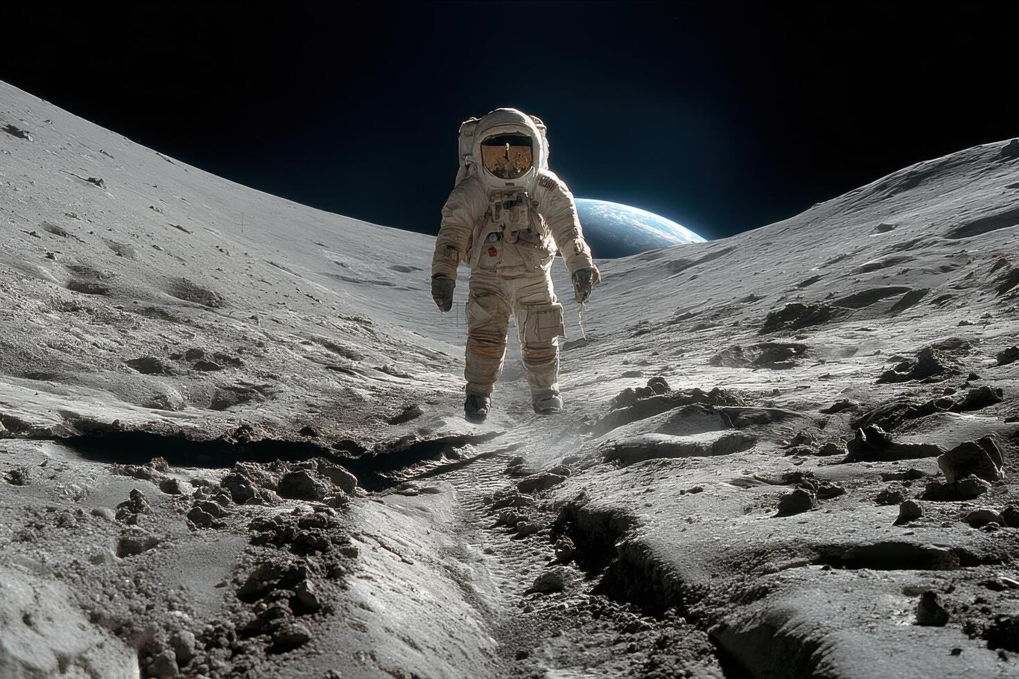 An astronaut walks on the Moon's surface, leaving footprints in the lunar dust with Earth shining brightly in the background photo