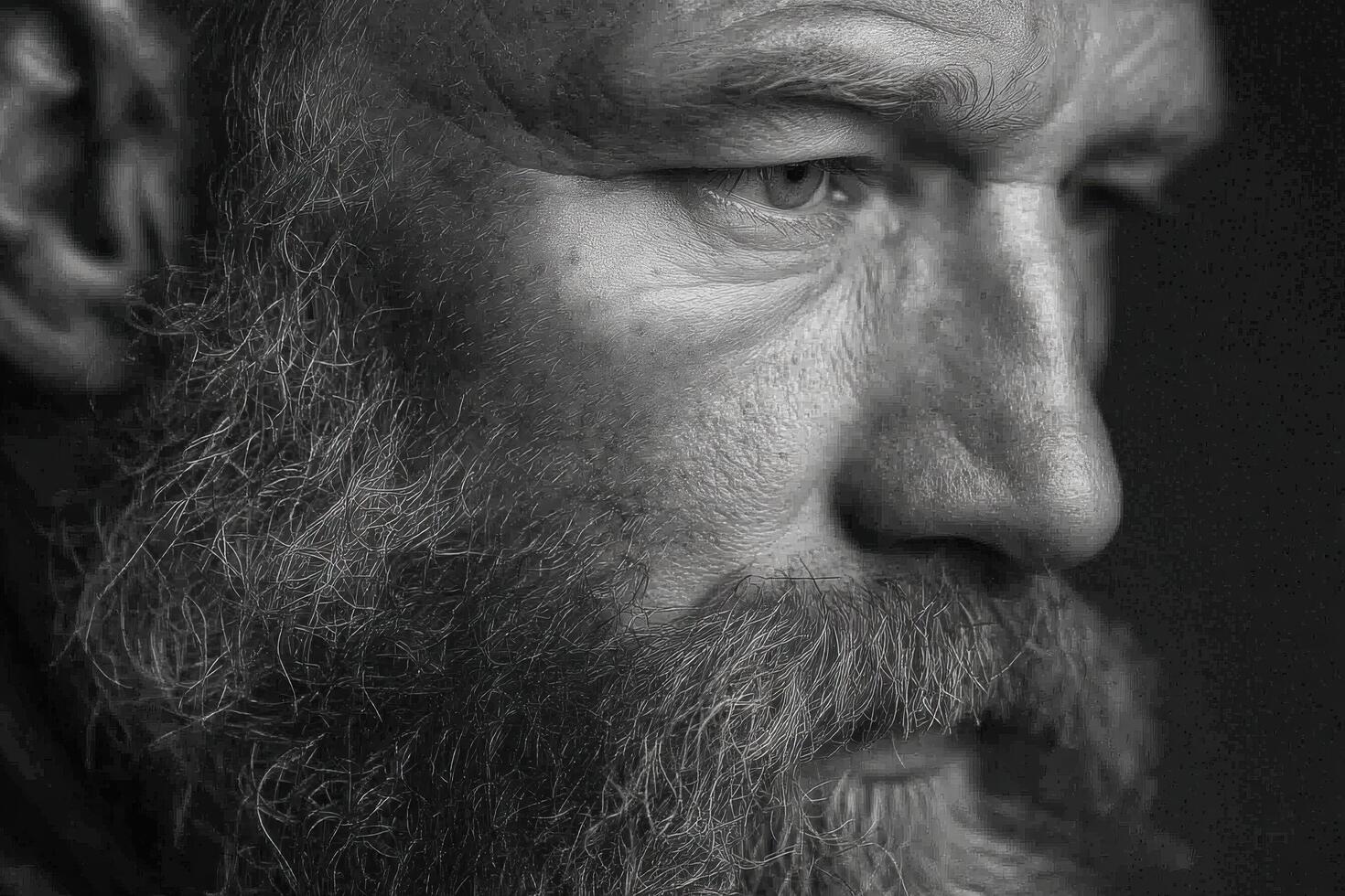 An elderly man with a thick beard gazes thoughtfully into the distance, his weathered features reflecting wisdom and experience photo