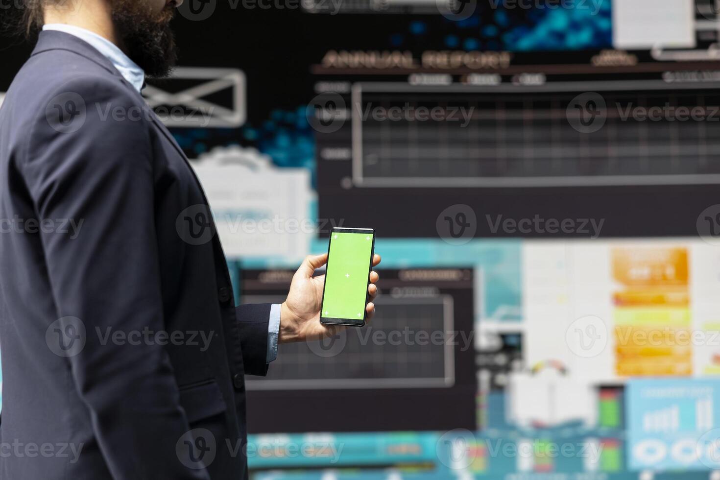 Professional man looks at green screen and explores strategy planning with insight and financial data in a digital workspace. Representing modern business intelligence and productivity. photo