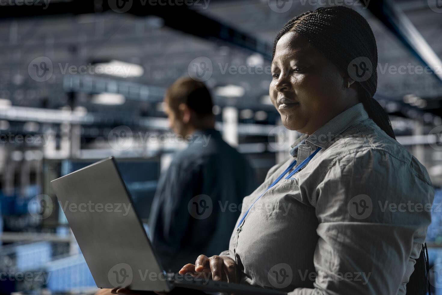 Teamworking data center programmers writing code for resource optimization using notebook. Server farm coworkers in data center refining algorithms for faster processing using laptop photo