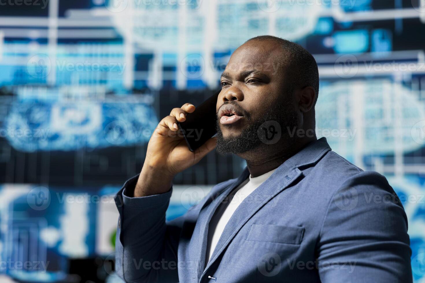 Black tech specialist talking on a smartphone call in an AI powered environment, representing predictive algorithms and machine learning systems. Working on automation and innovation. photo