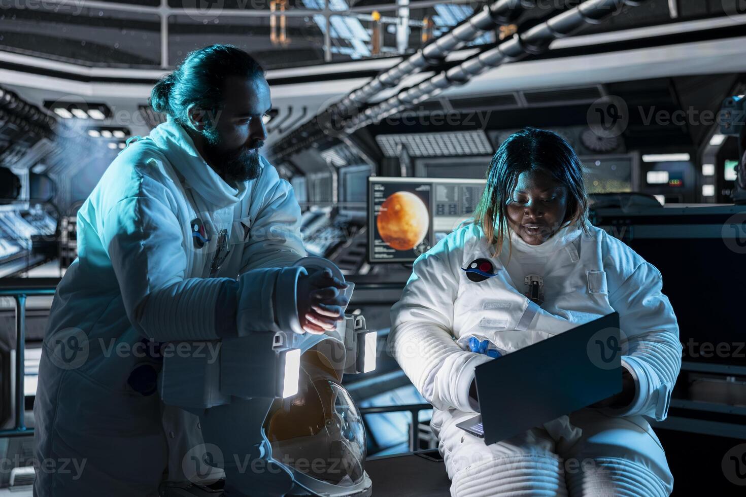 Teamworking astronauts use tablet to ensure safe operation during long distance space travel to Mars. Orbital station crew monitors system stability during cosmic journey to red planets photo