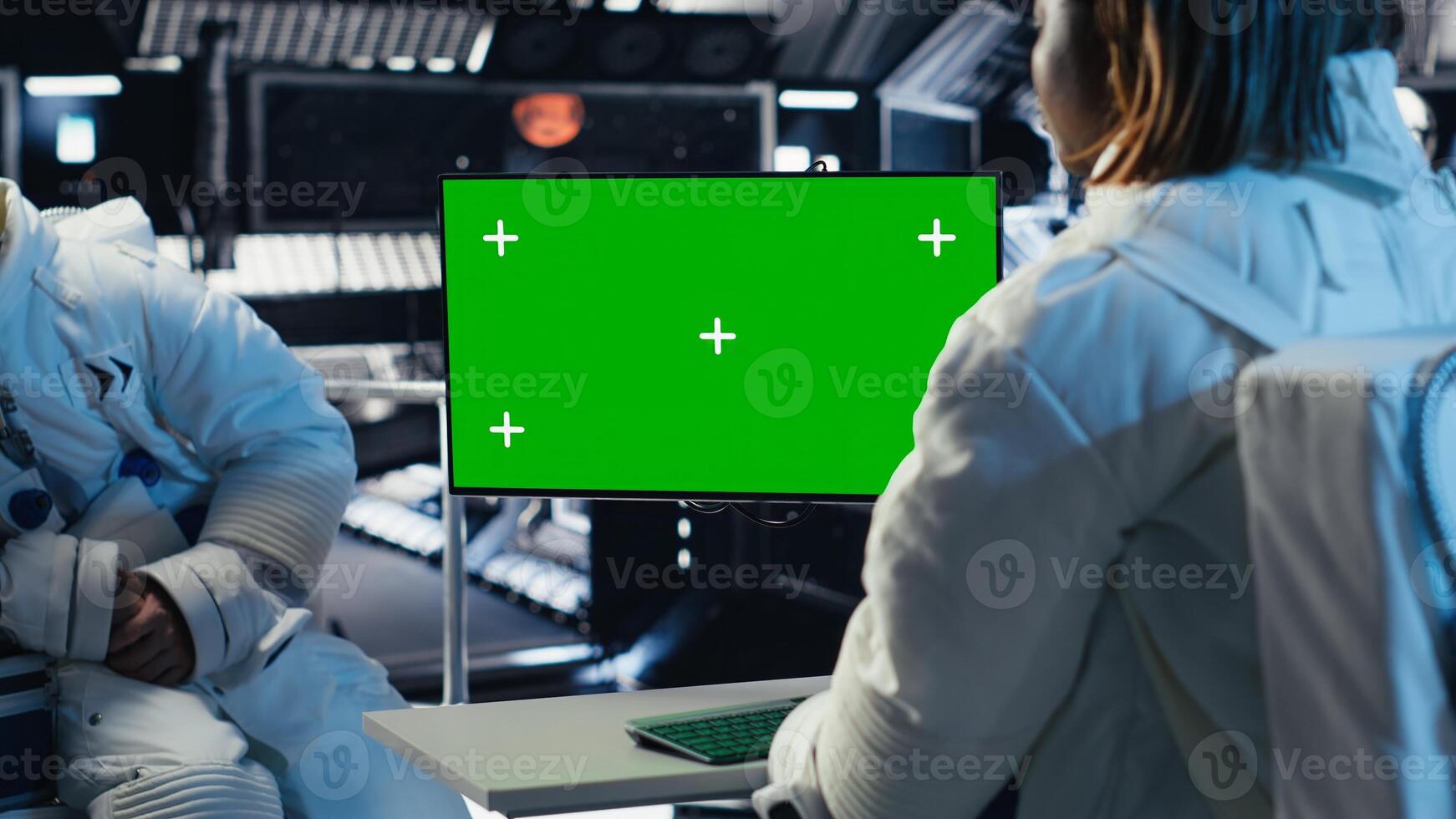 Team of cosmonauts calibrating starship sensors using isolated screen monitor, preparing for mission. Astronauts using chroma key display, beginning landing procedures on solar system planet photo
