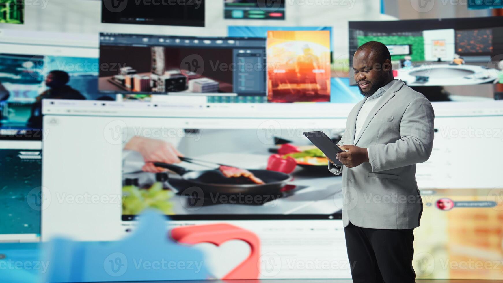 Joyous man using tablet, receiving personalized recommendations delivered instantly. Upbeat user using device, enjoying digital era enabling unlimited streaming opportunities, camera A photo