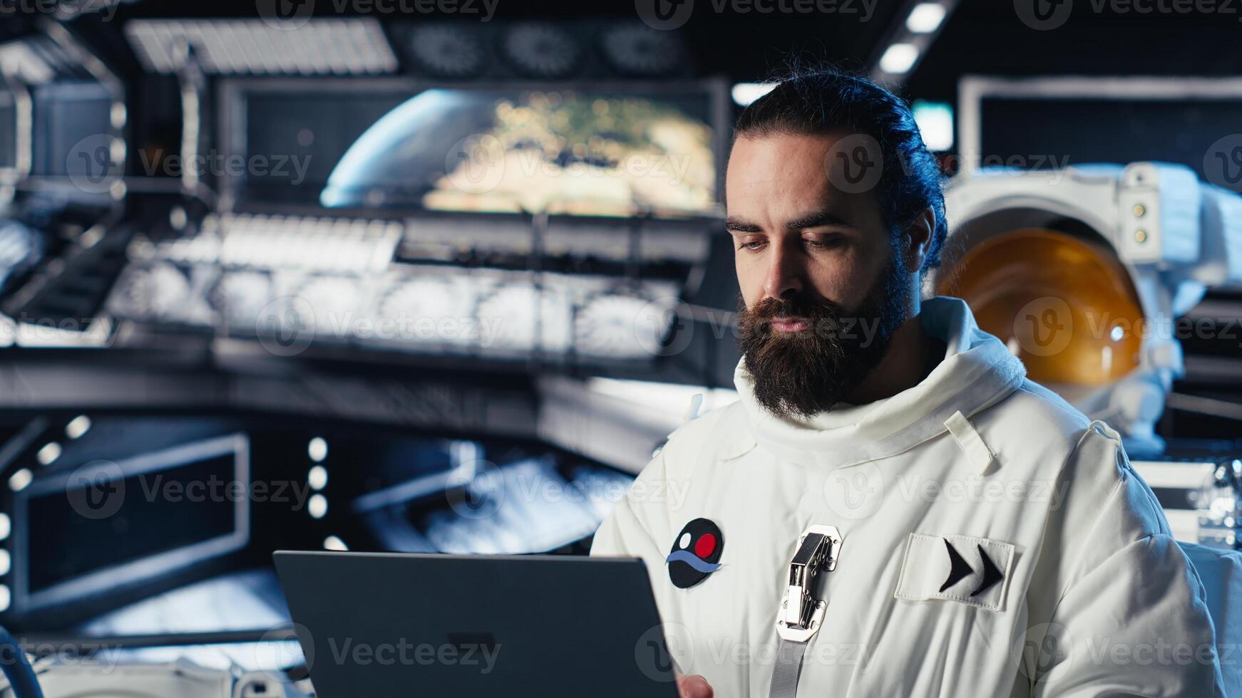 Astronaut using laptop to verify mission parameters after completing planet surface expedition. Cosmonaut manages systems using notebook, leaving Mars, updating flight log to return home photo