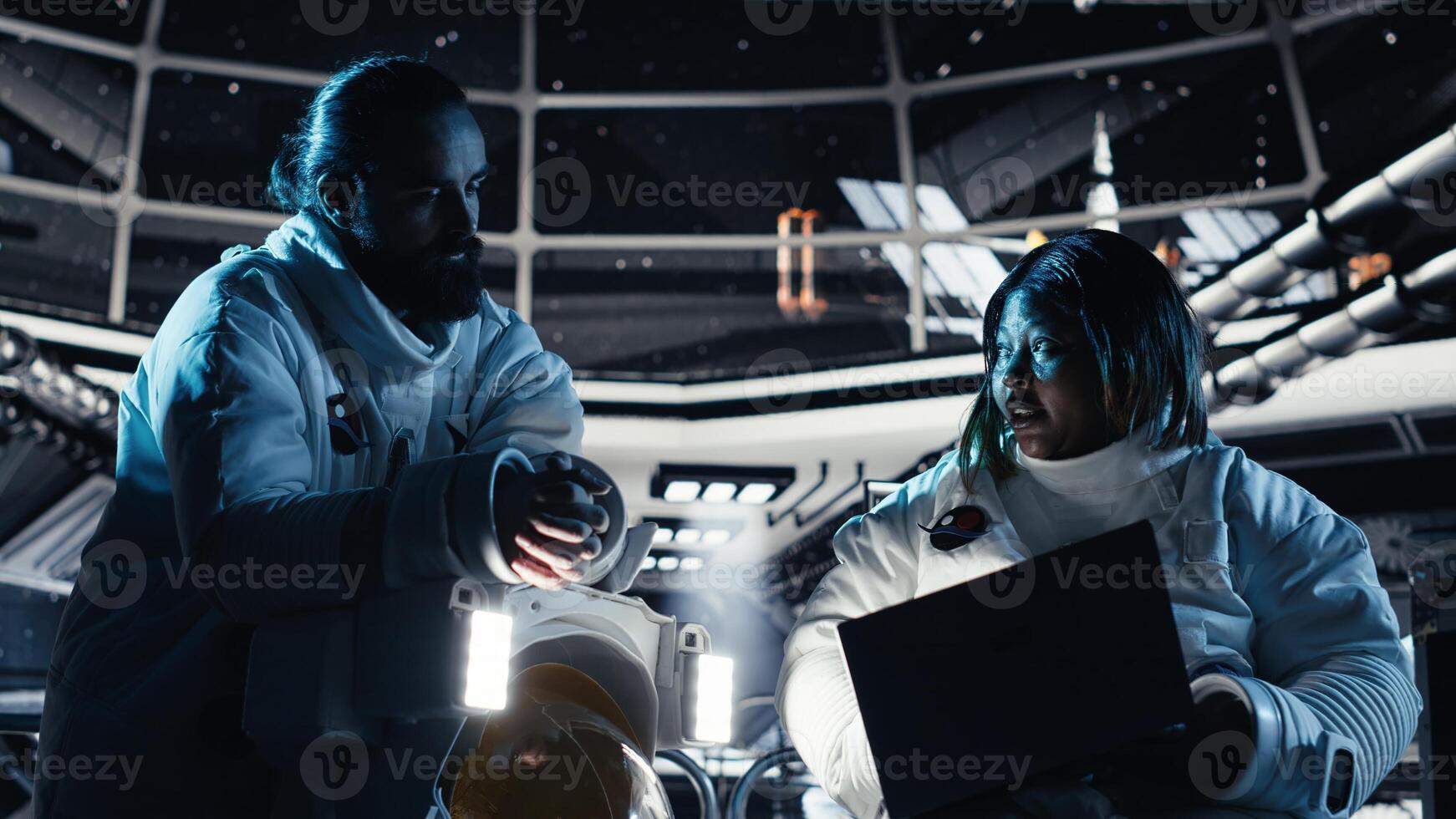 Team of astronauts running data analysis on laptop before stepping out outside space station. Teamworking cosmonaut verifying mission parameters on notebook after landing on planet photo