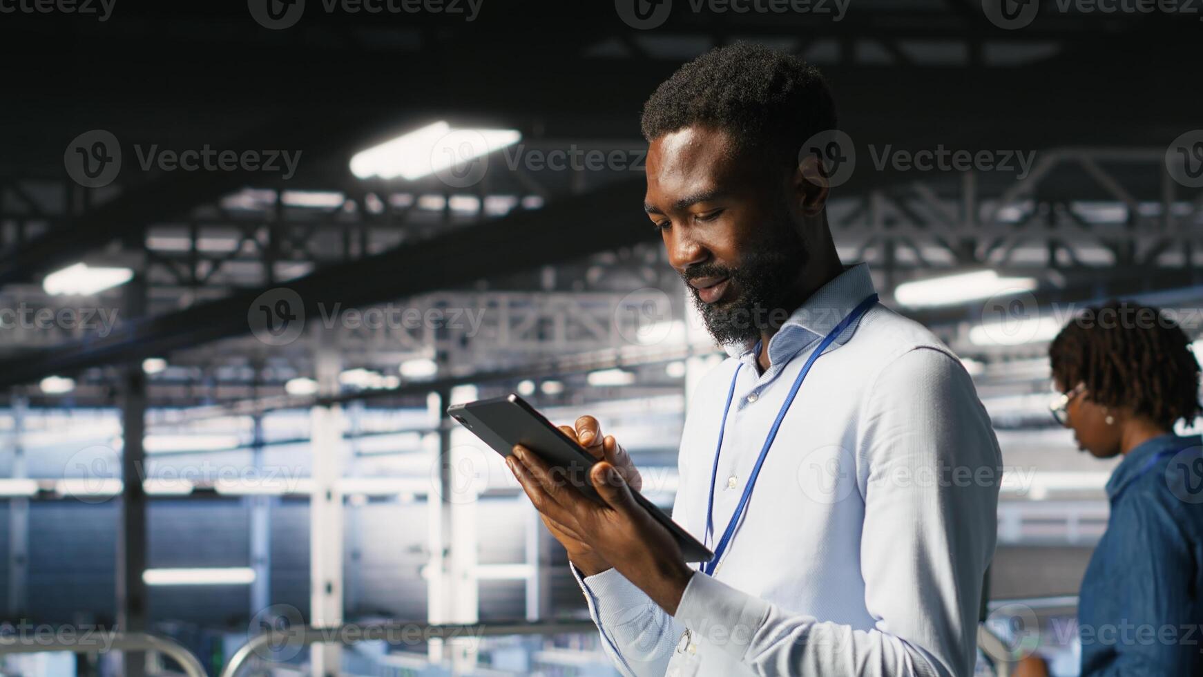 Software developers on data center industrial platform analyzing performance outputs on devices. Server room IT specialists collaborating on finetuning mainframes configurations photo