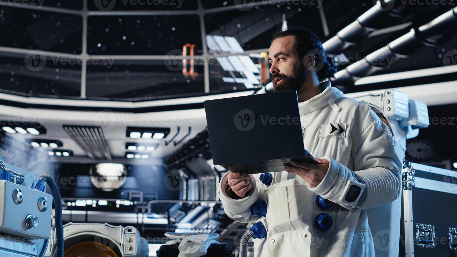Astronaut reviewing onboard analytics on laptop before stepping out for scheduled operations outside space station. Cosmonaut verifying mission parameters after landing on alien planet photo