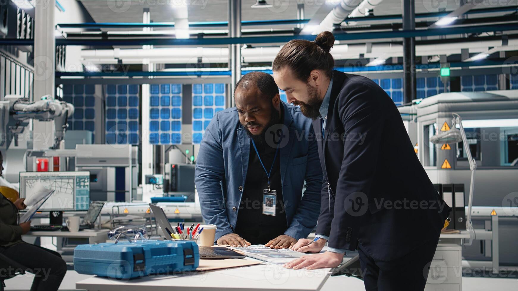 Multiethnic engineers industrial coworkers doing teamwork on production line for solar panels, combining technical insight and teamwork to drive forward clean energy infrastructure. Camera A. photo