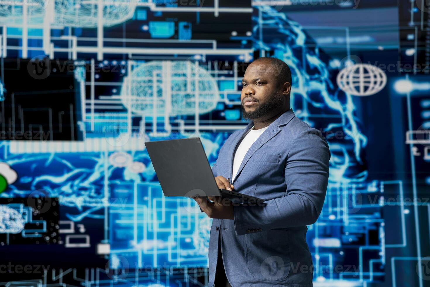 Black businessman using smart technology to interact with cybernetic platforms and AI interfaces, representing the integration of machine learning and predictive analytics in modern development. photo