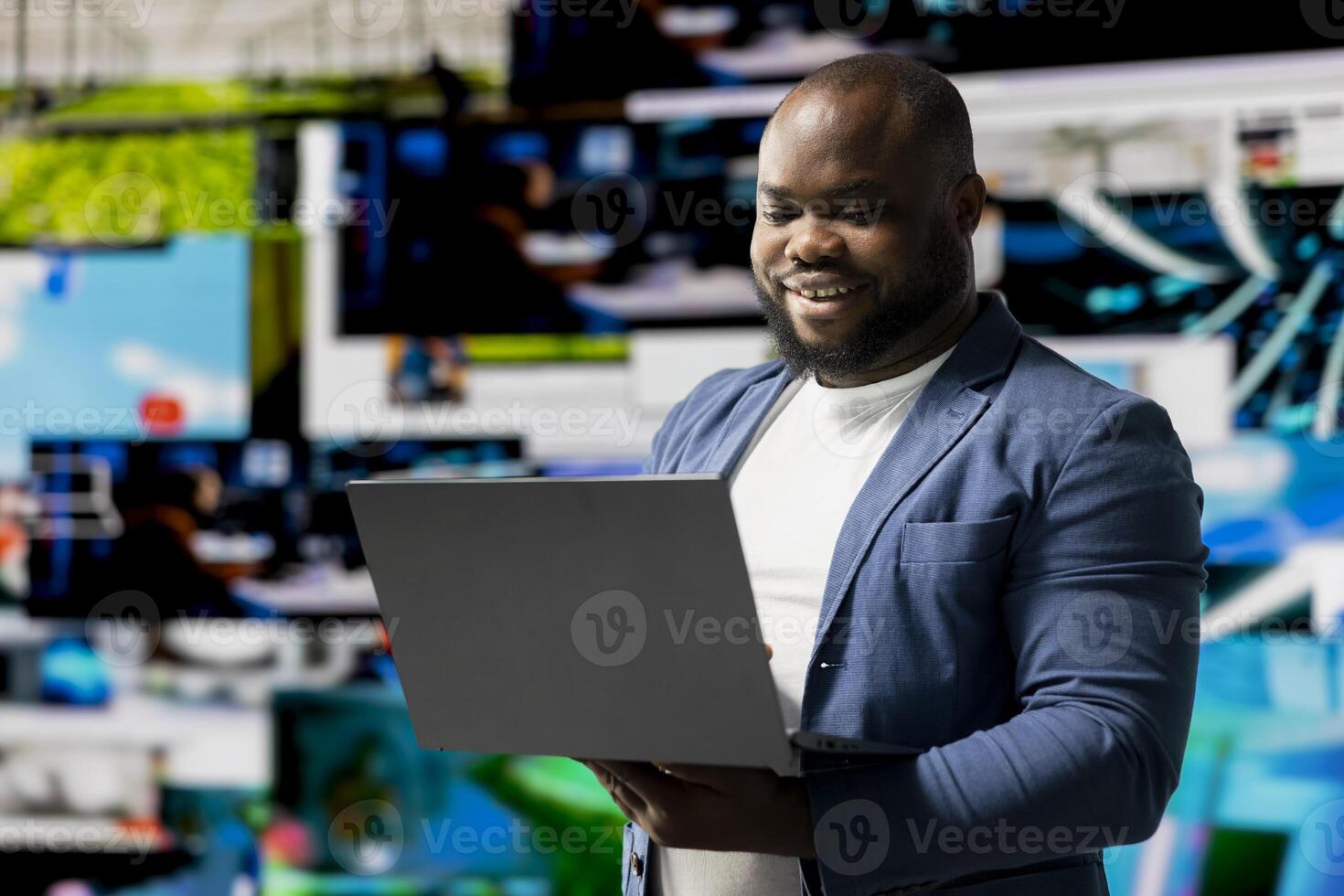 African American user emphasizing visual concept of online communication, connecting to web platforms and apps. Mobile technology surrounded by social network icons in a digital space. photo