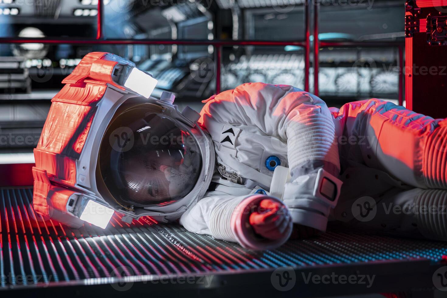 Space traveler lies motionless on floor, affected by low oxygen levels after critical systems shut down. Orbit station red light flashing and crew member passing out from environmental hazard photo