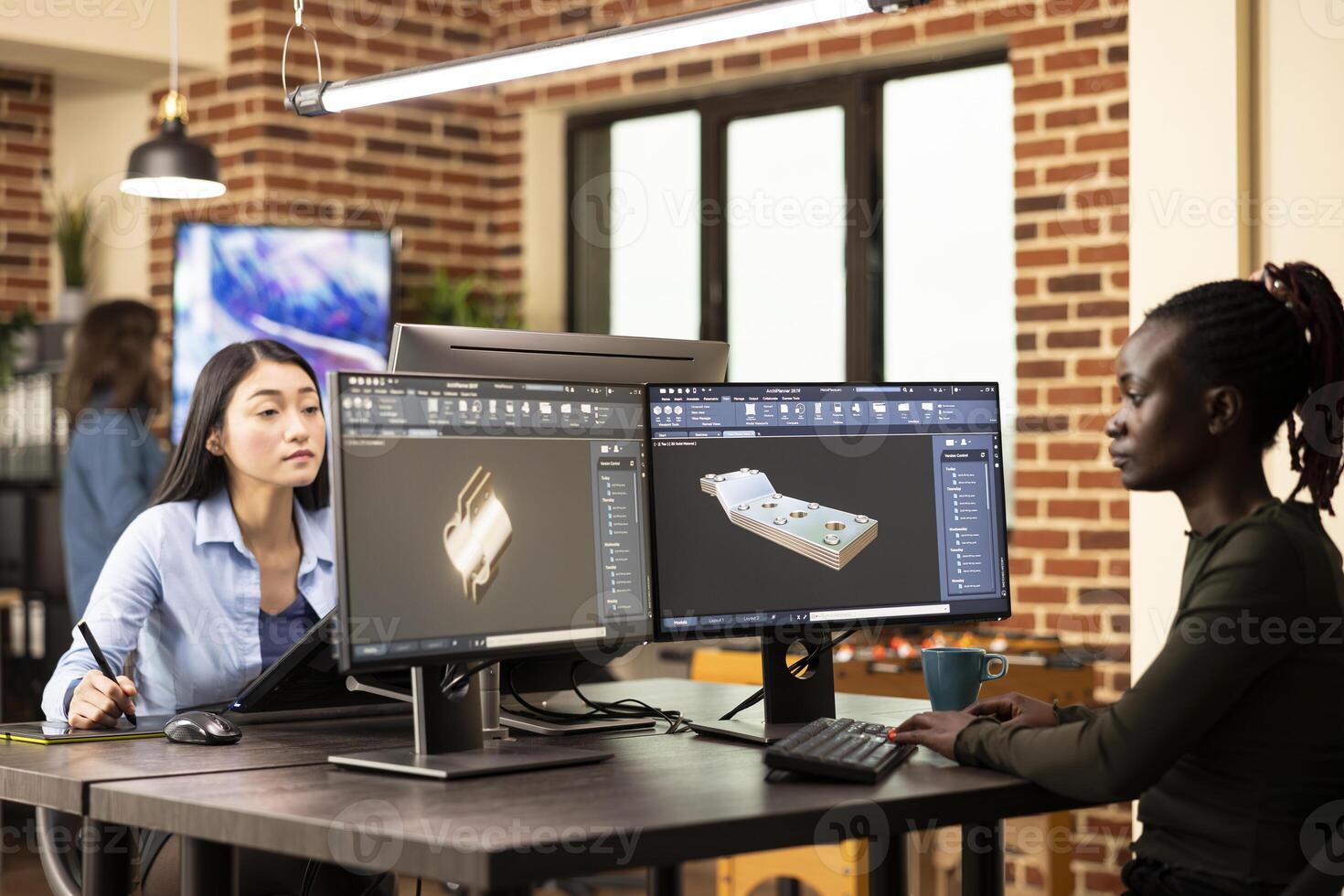 Black female engineer seated at shared workstation, developing industrial machinery models with advanced CAD software. Woman developer creating technical machine prototypes for construction industry. photo