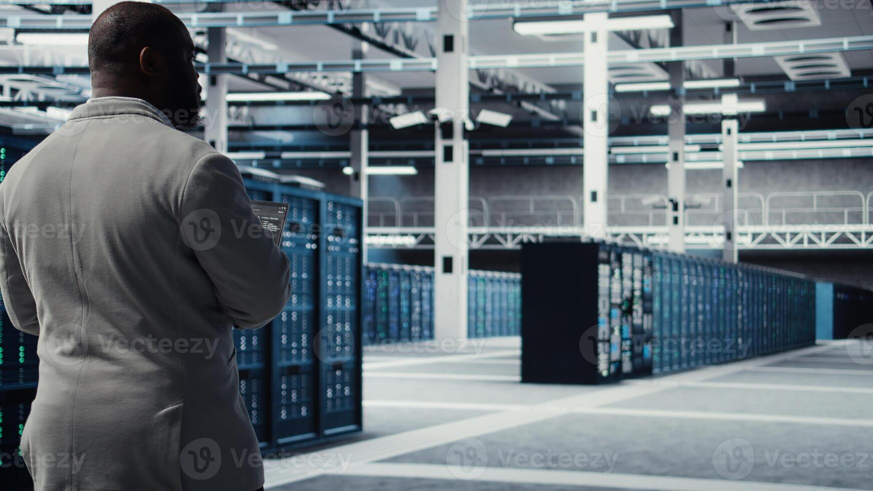 Engineer walking in data center using device to configure hardware optimized for AI tasks. Man doing maintenance on rigs performing load balancing for artificial intelligence computing, camera A photo