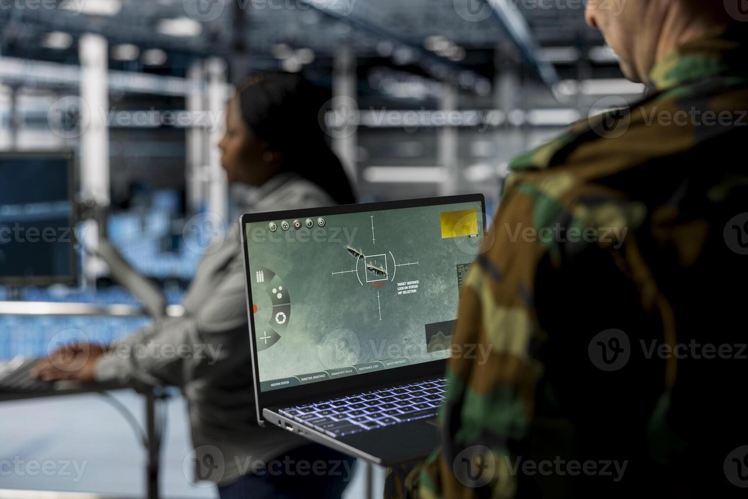 Close up of military officer in data center looking at missile lock interface displayed on laptop screen. Soldier in army server hub checking target coordinates and crosshair overlay on notebook photo