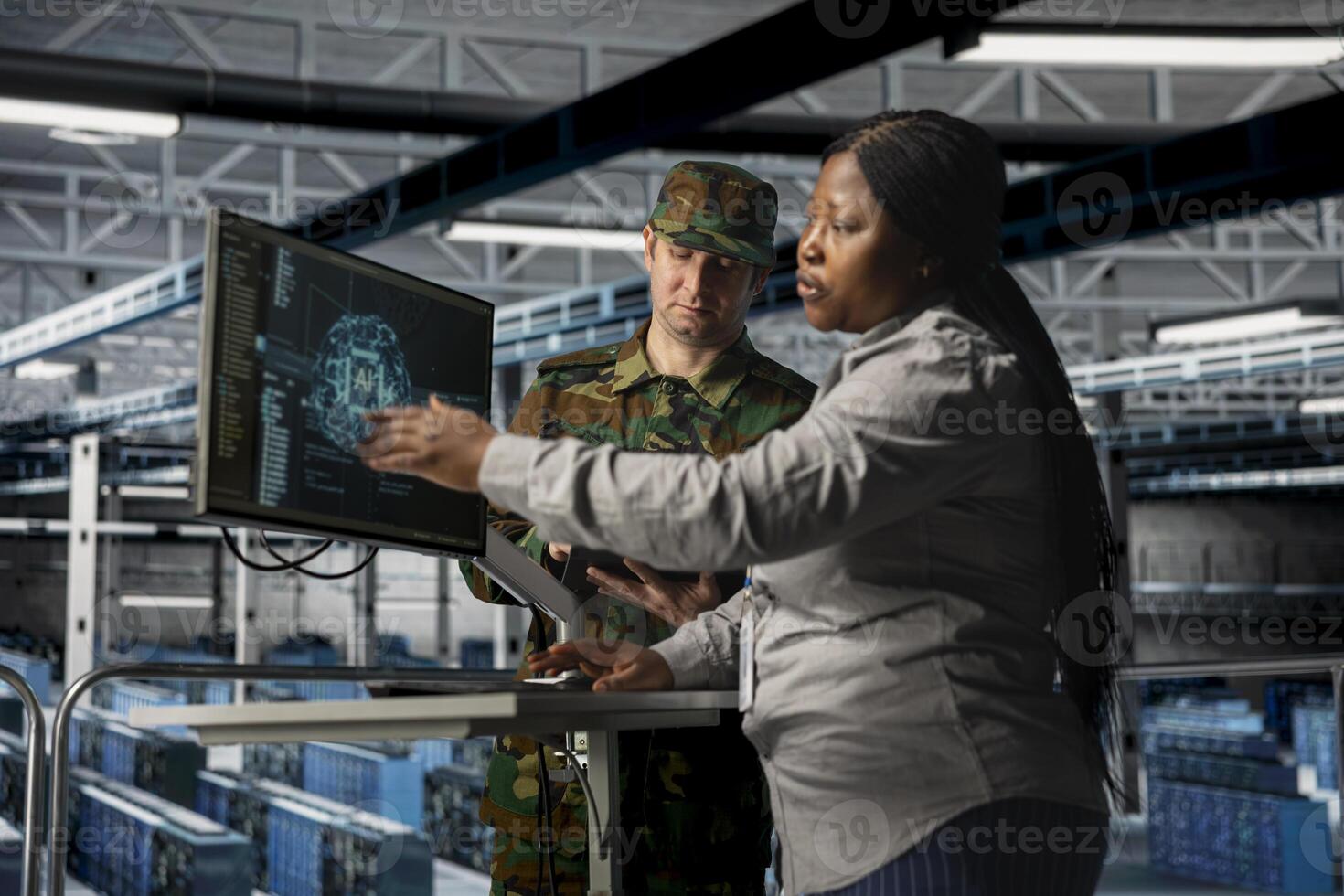 Server room army specialists reviewing insights to support operational strategies. Military server room colleagues checking mission critical systems using artificial intelligence photo