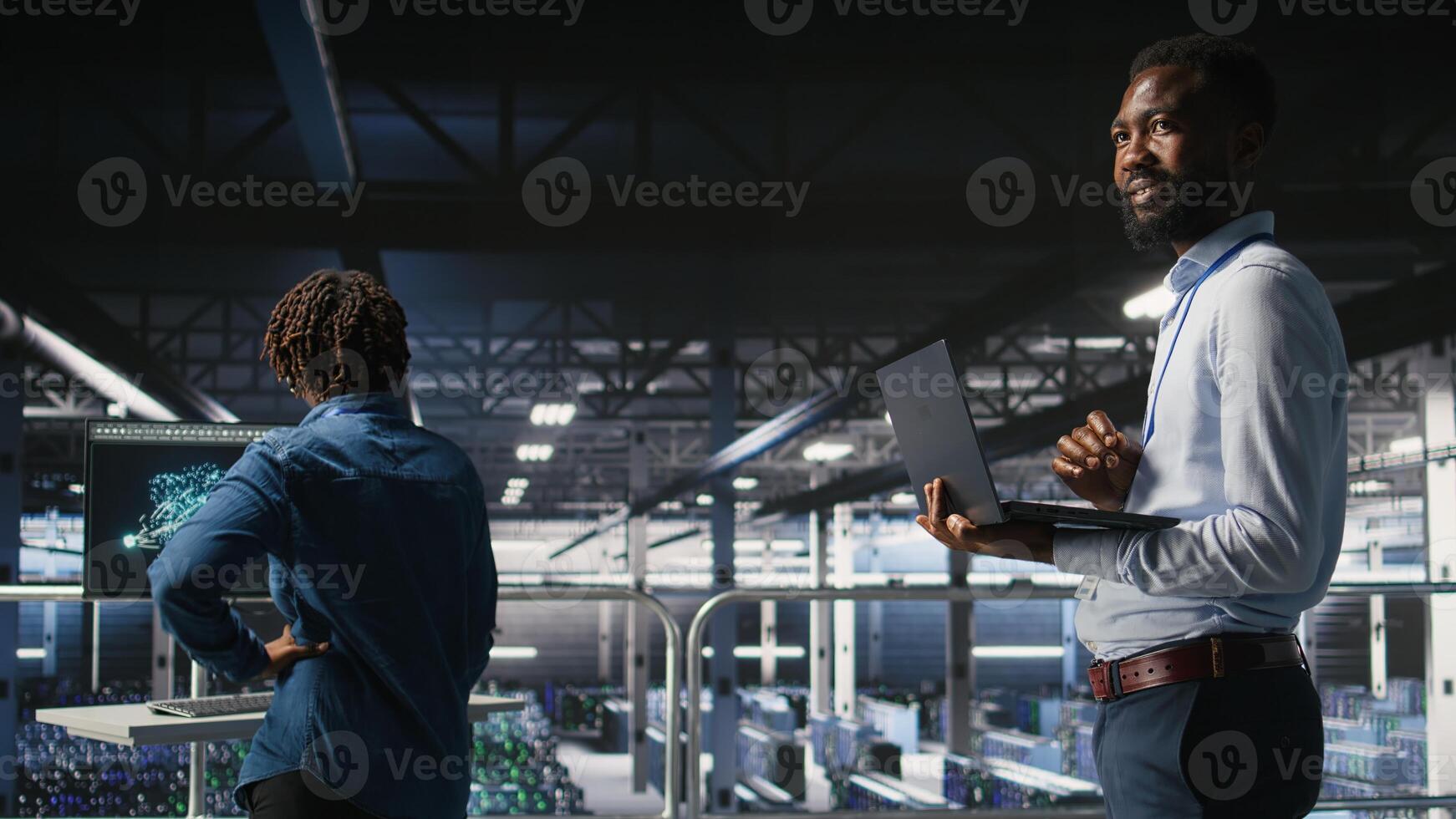 IT experts on data center industrial platform pleased by neural network outputs after completing AI software updates. Cheerful system administrators finetuning server rig configurations, photo