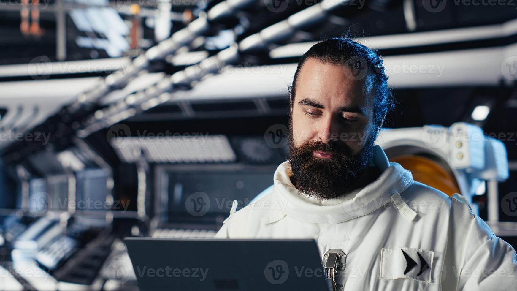 Astronaut checking human expansion in space mission data on laptop during cosmic journey. Orbit station crew managing systems using notebook during mankind survival expedition photo