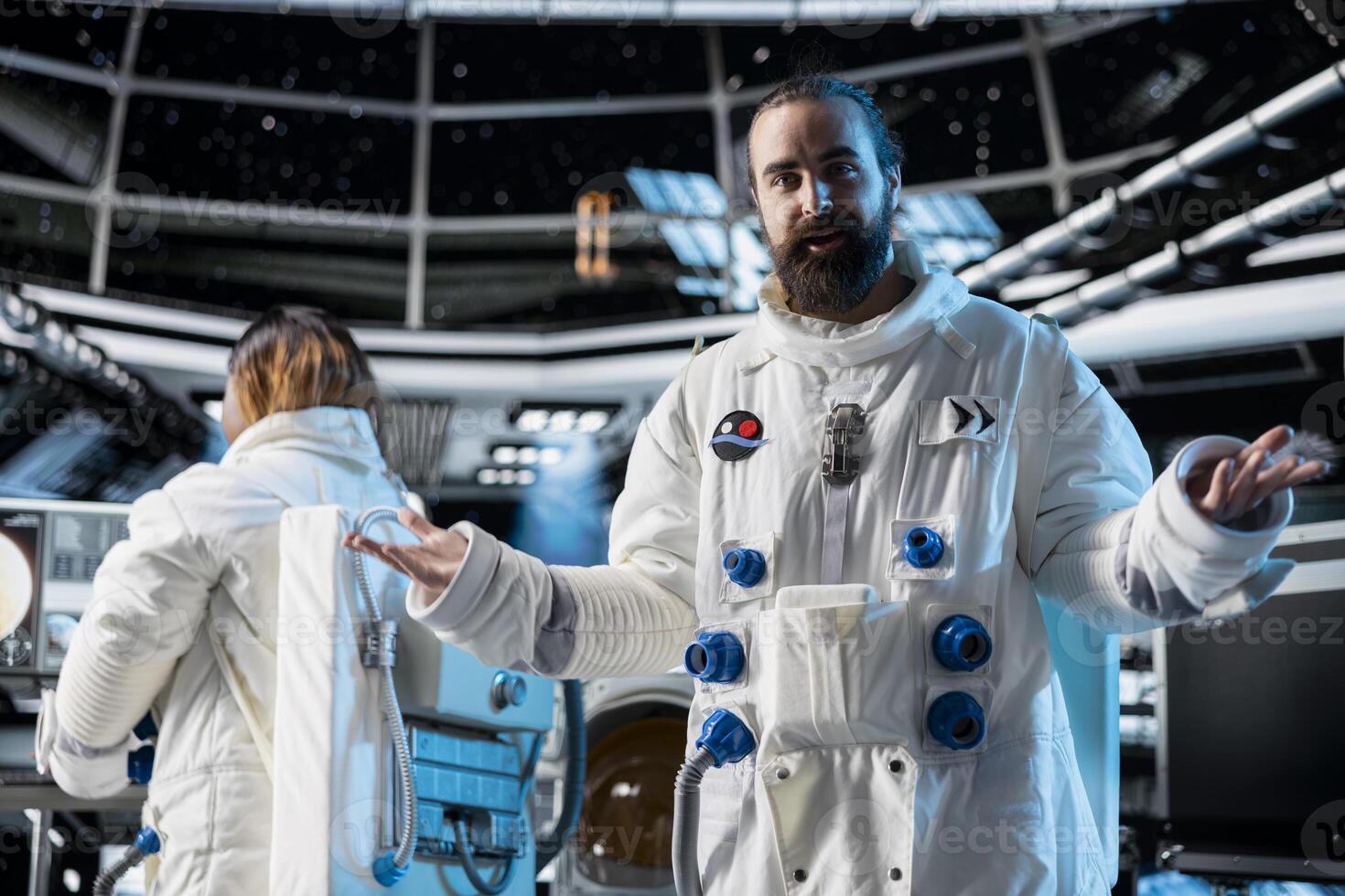 Cheerful astronaut discusses with command center researchers on Earth during videocall from space station. Happy man in starship reports mission progress and confirms system status with ground control photo