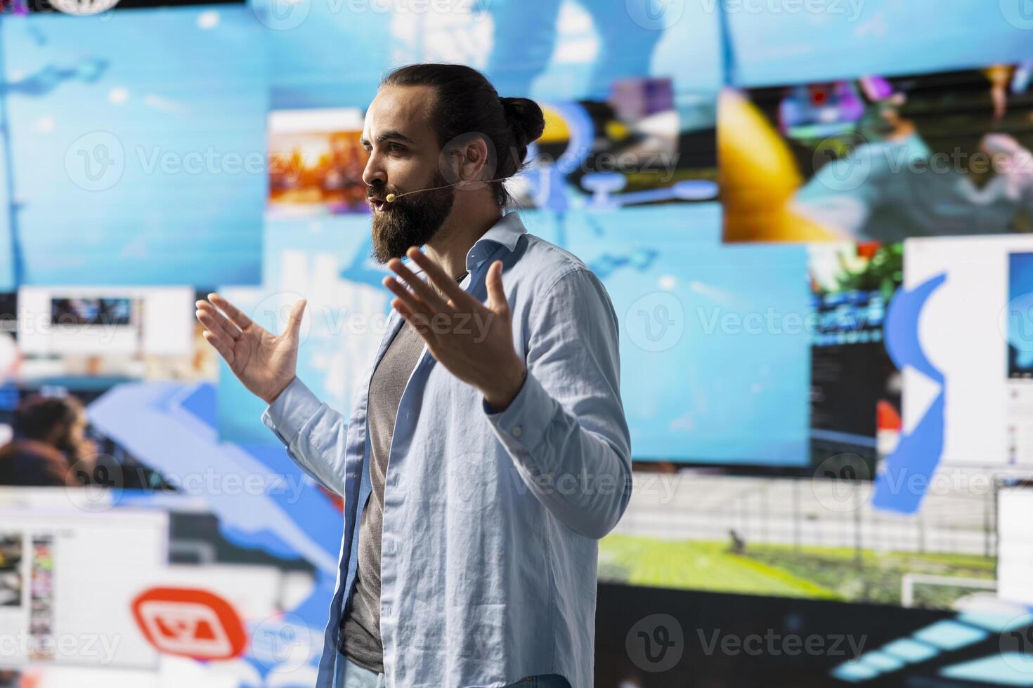 Male live presenter communicating to an online audience about branding strategy and social trends, using microphone during presentation to help enhance engagement and global reach. photo