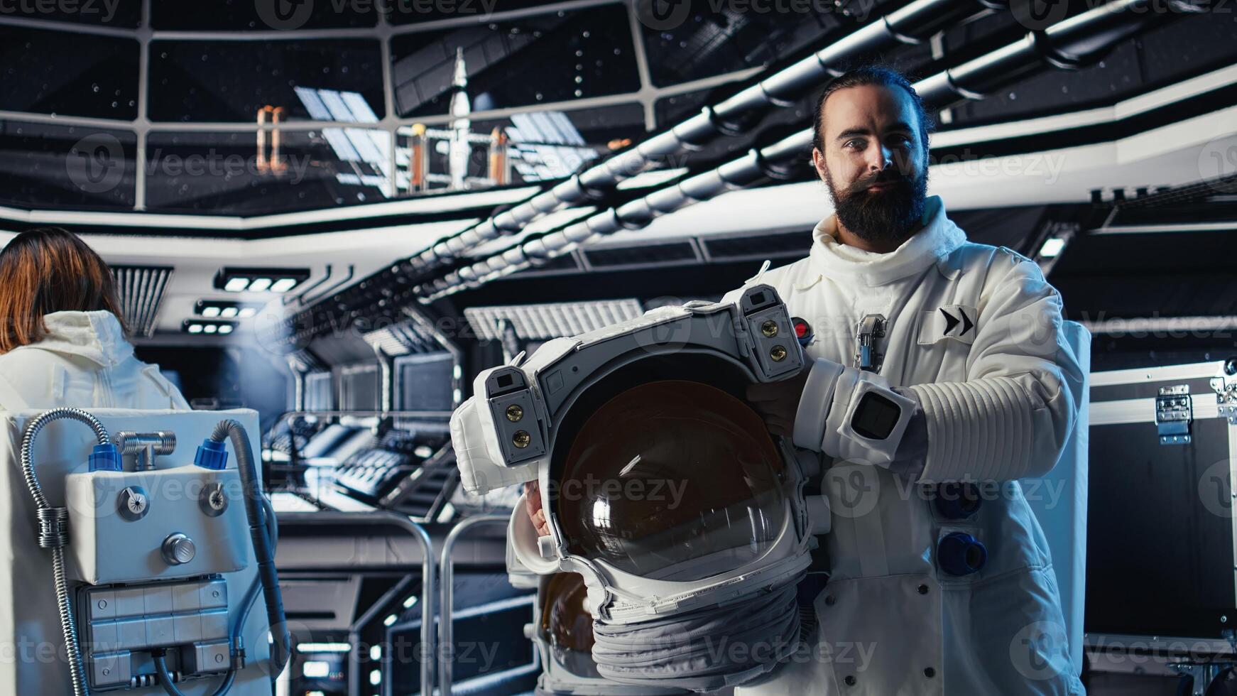 Portrait of smiling astronaut holding protection helmet doing human expansion in space. Jolly man in starship prepares for expedition supporting long term mankind survival photo