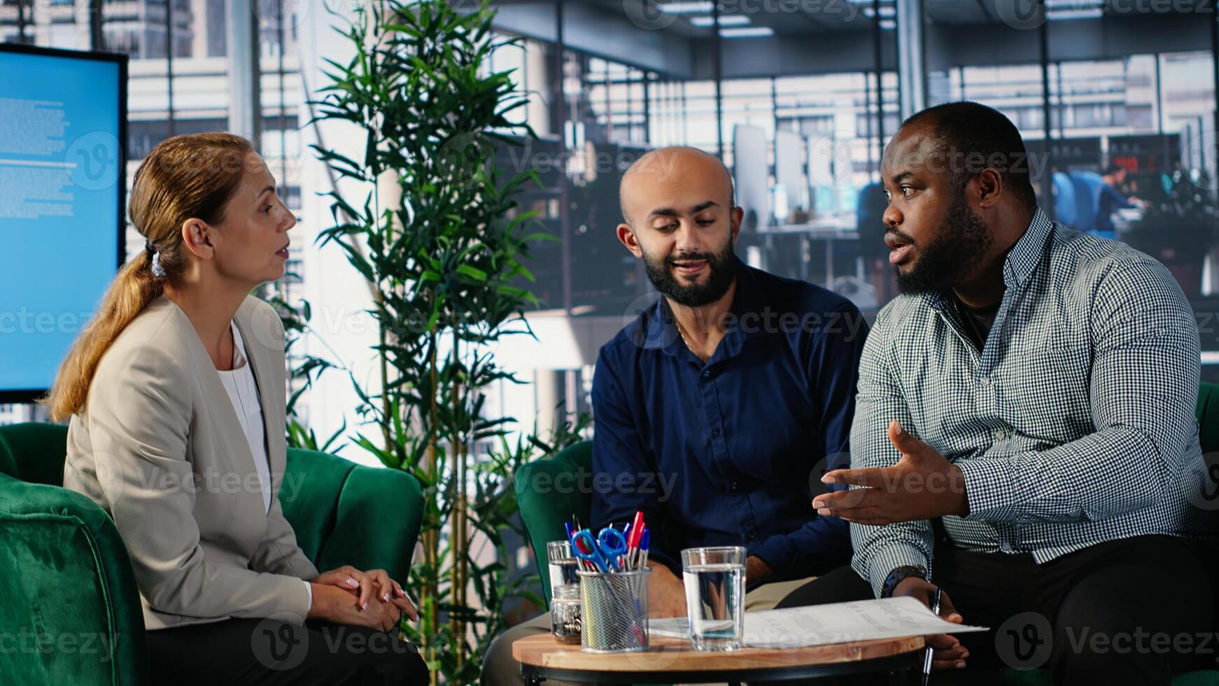 Business meeting in corporate office involving executive decision making, strategic thinking and planning. Diverse professionals ensure organizational growth and performance metrics. Camera B. photo