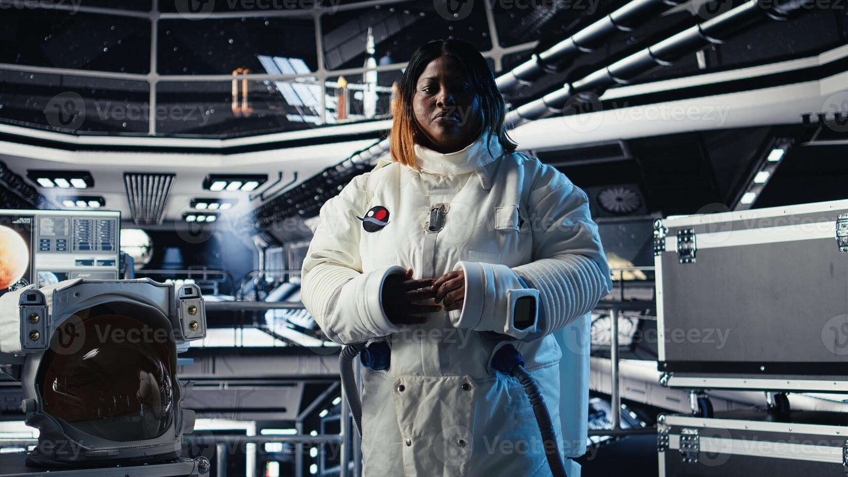 Happy female astronaut saluting command center researchers during videocall, sharing recent discoveries. African american woman in spaceship provides scientific findings to Earth team photo