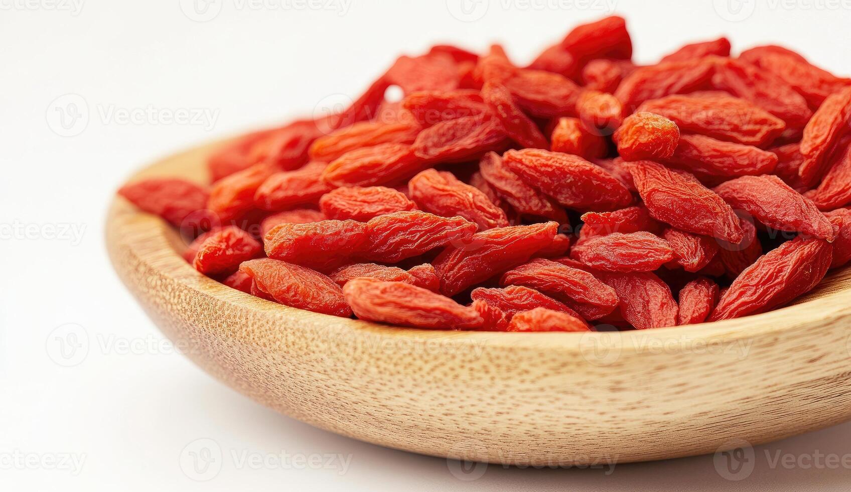 Dried red berries in a wooden bowl photo