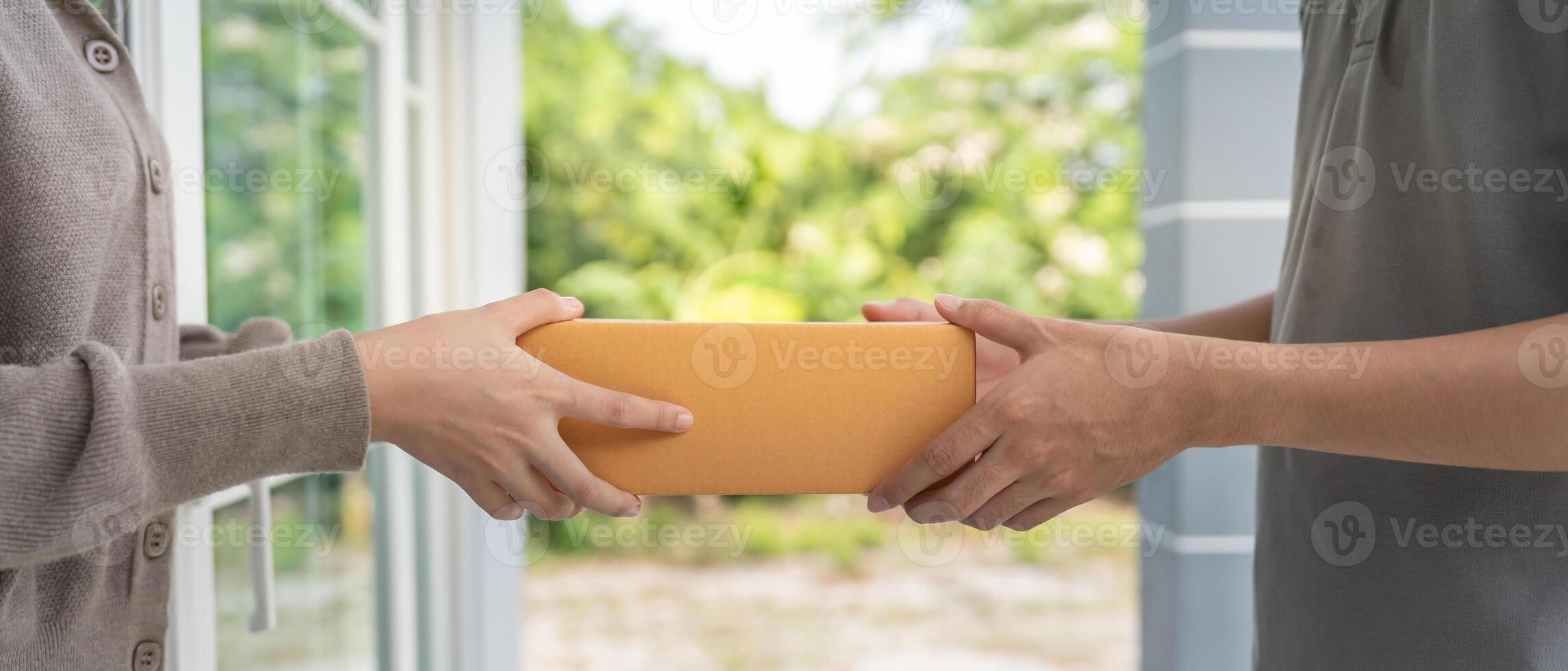 Asian woman receive paper bag parcel of food from courier front house. Delivery man send deliver express. online shopping, paper container, takeaway, postman, delivery service, packages photo