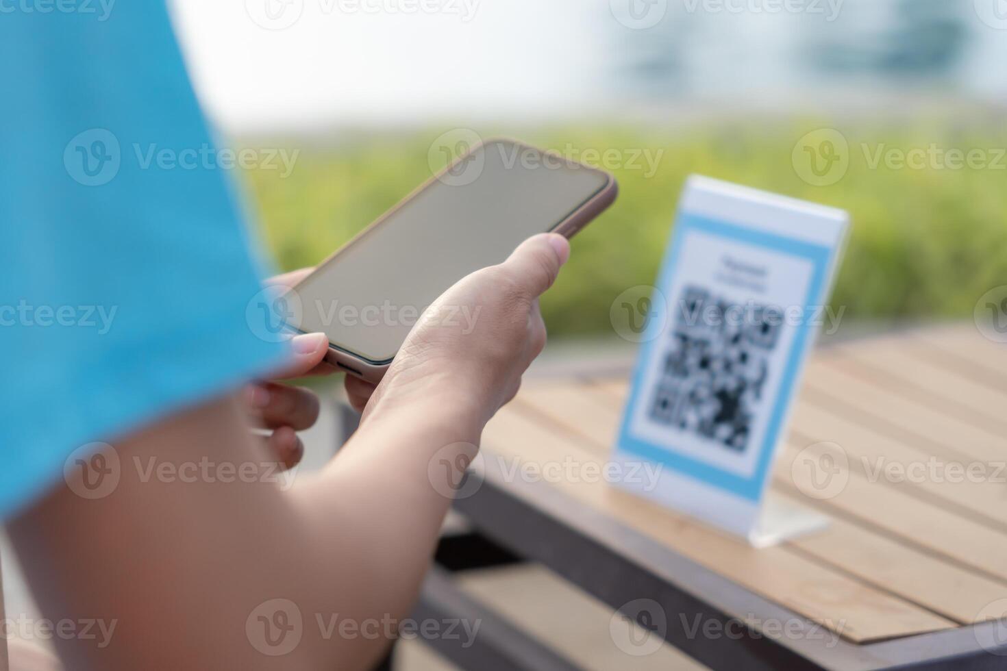 smartphone to scan QR code for order menu in cafe restaurant with a digital delivery. Choose menu and order accumulate discount. E wallet, technology, pay online, credit card, bank app photo