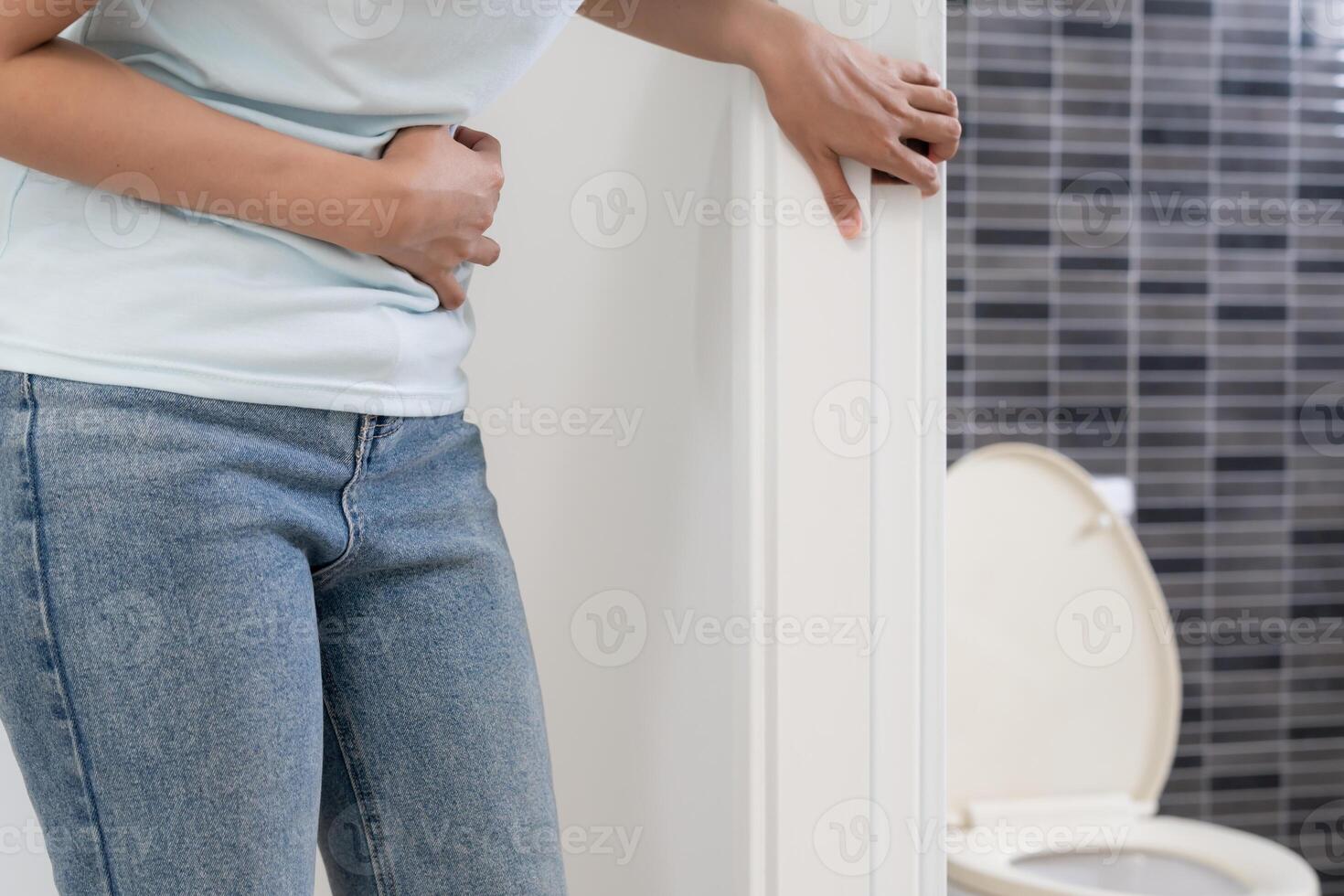 Hurt woman touch belly stomach ache painful. colon inflammation problem, toxic food, abdominal pain, abdomen, constipated in toilet, stomachache, Hygiene. Constipation and diarrhea in bathroom photo