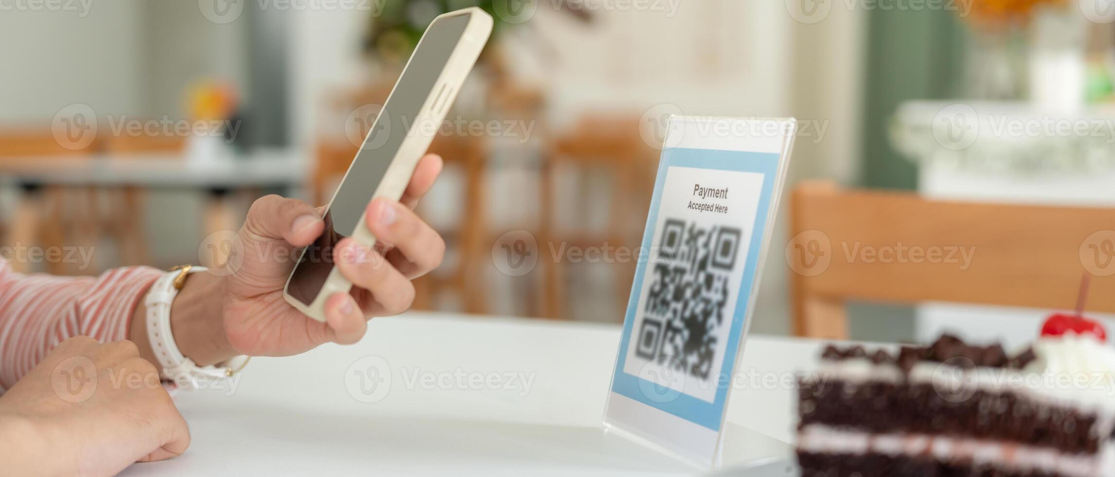 Woman use smartphone to scan QR code for order menu in cafe restaurant with a digital delivery. Choose menu and order accumulate discount. E wallet, technology, pay online. credit card. photo