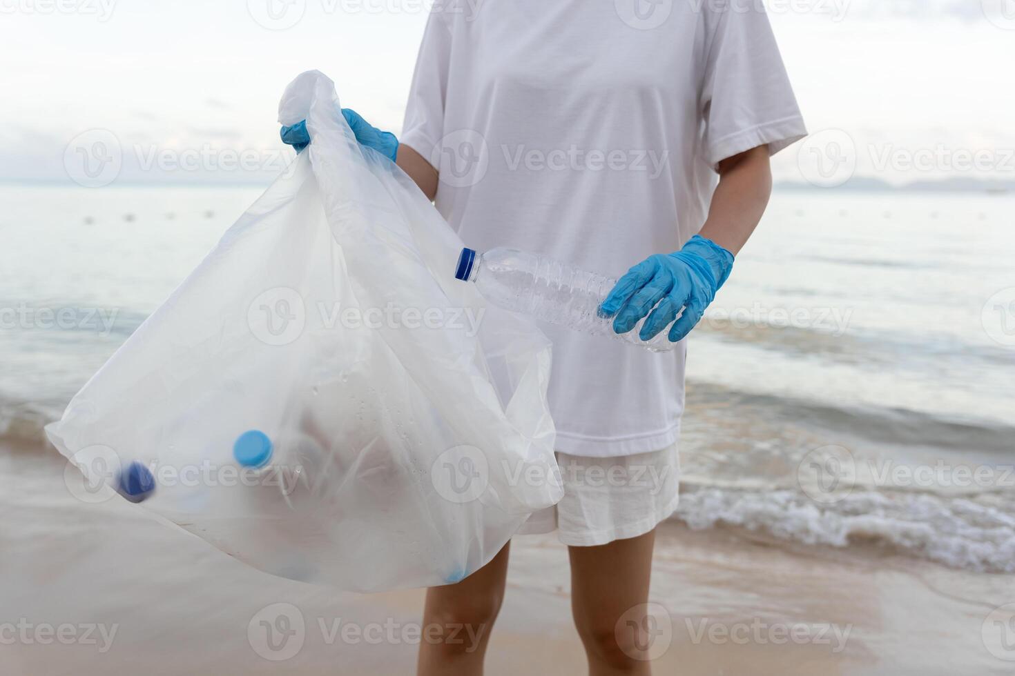Save ocean. pick up trash garbage at the beach and plastic bottles are difficult decompose prevent harm aquatic life. Earth, Environment, Greening planet, reduce global warming, Save world photo