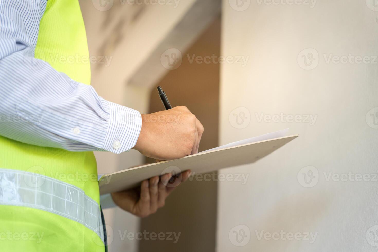 inspector or engineer is inspecting construction and quality assurance new house using a checklist. Engineers or architects or contactor work to build the house, photo