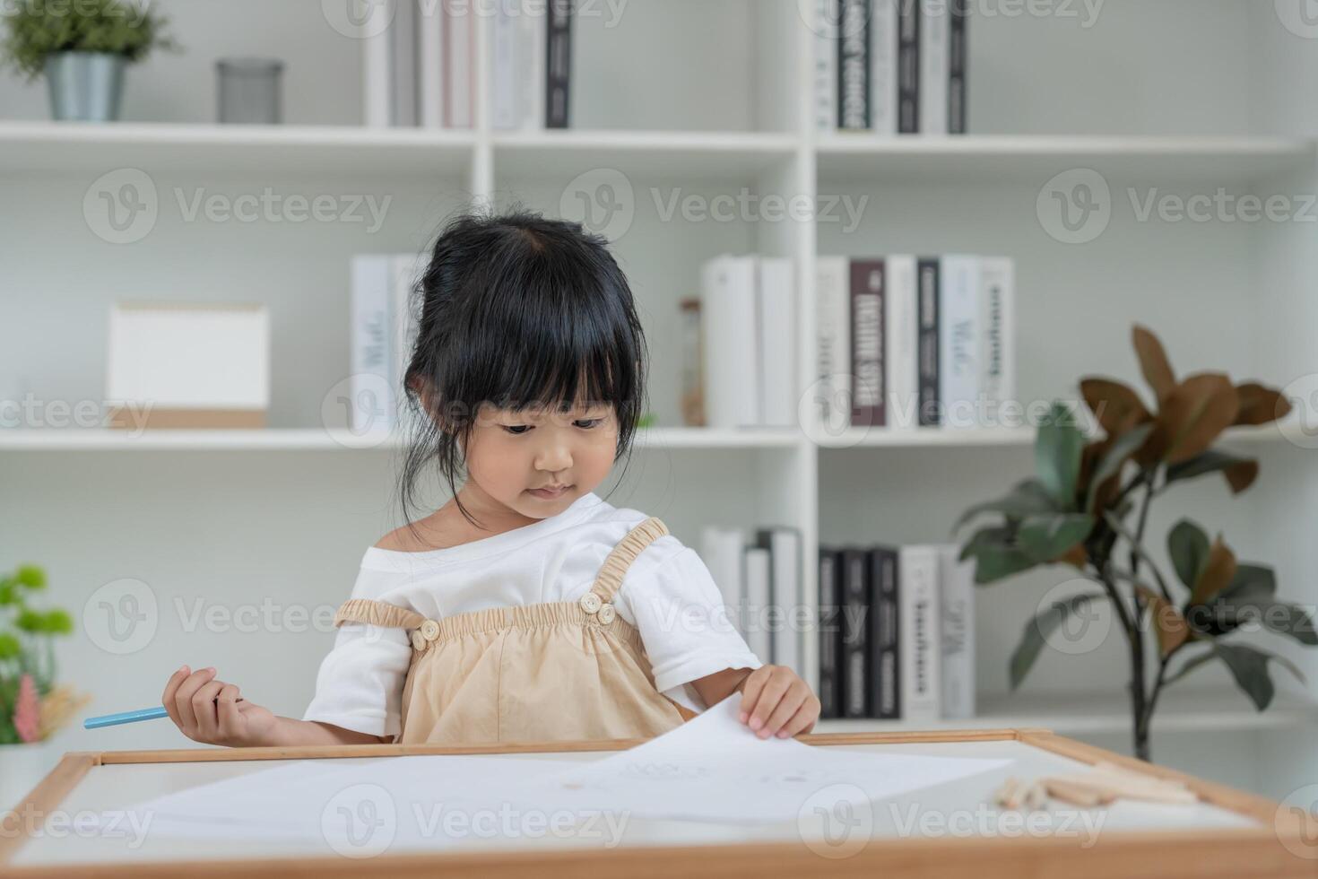 Happy Asian child play and learn drawing picture and cartoon. Funny family is happy and excited in the house. Mother and daughter having fun spending time together. Holiday, Activity photo