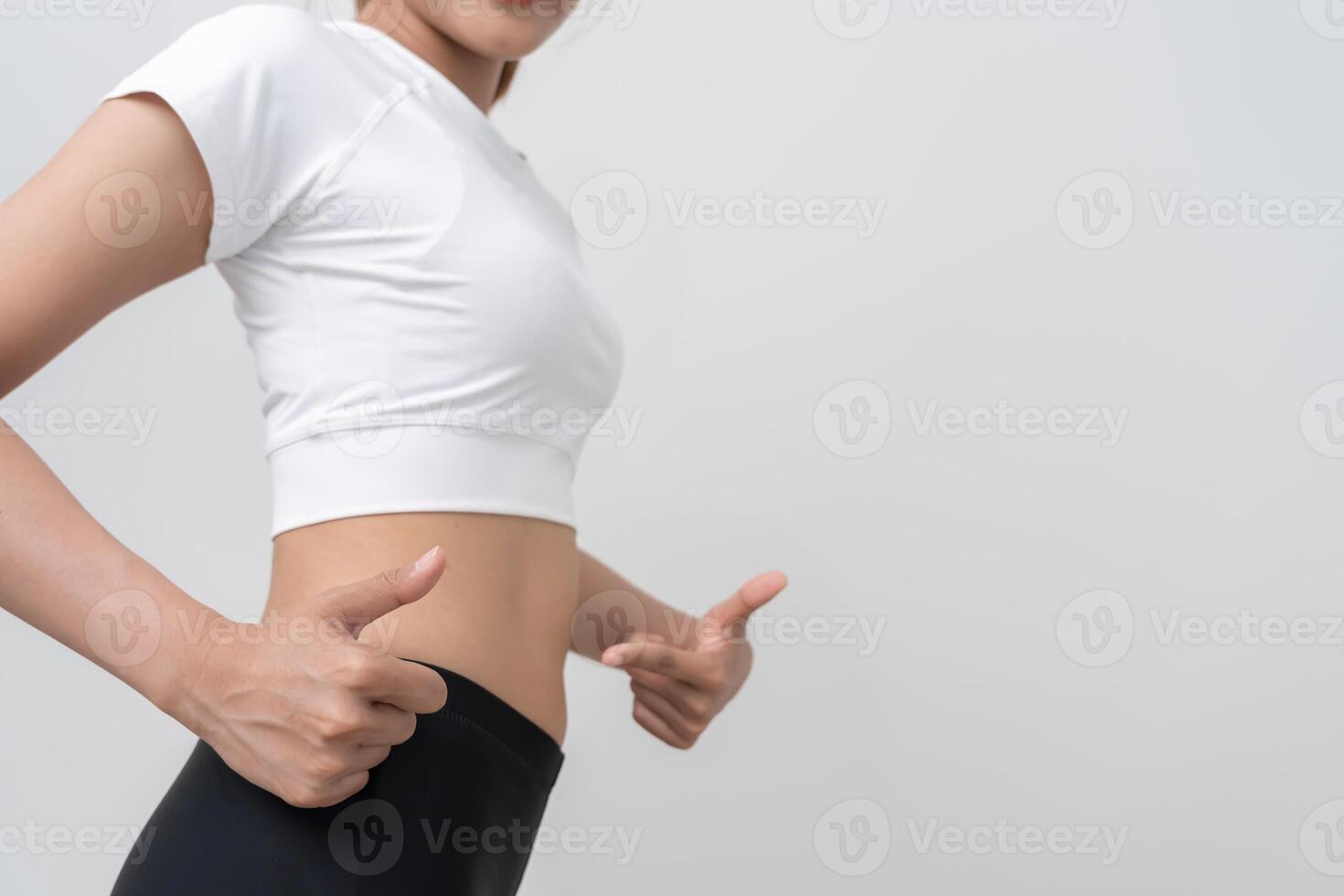 women happy results of diet. Beautiful shape. female have a reduced waist size after under going a weight loss corse. can not wear jean due to weight loss. balance, control, routines photo