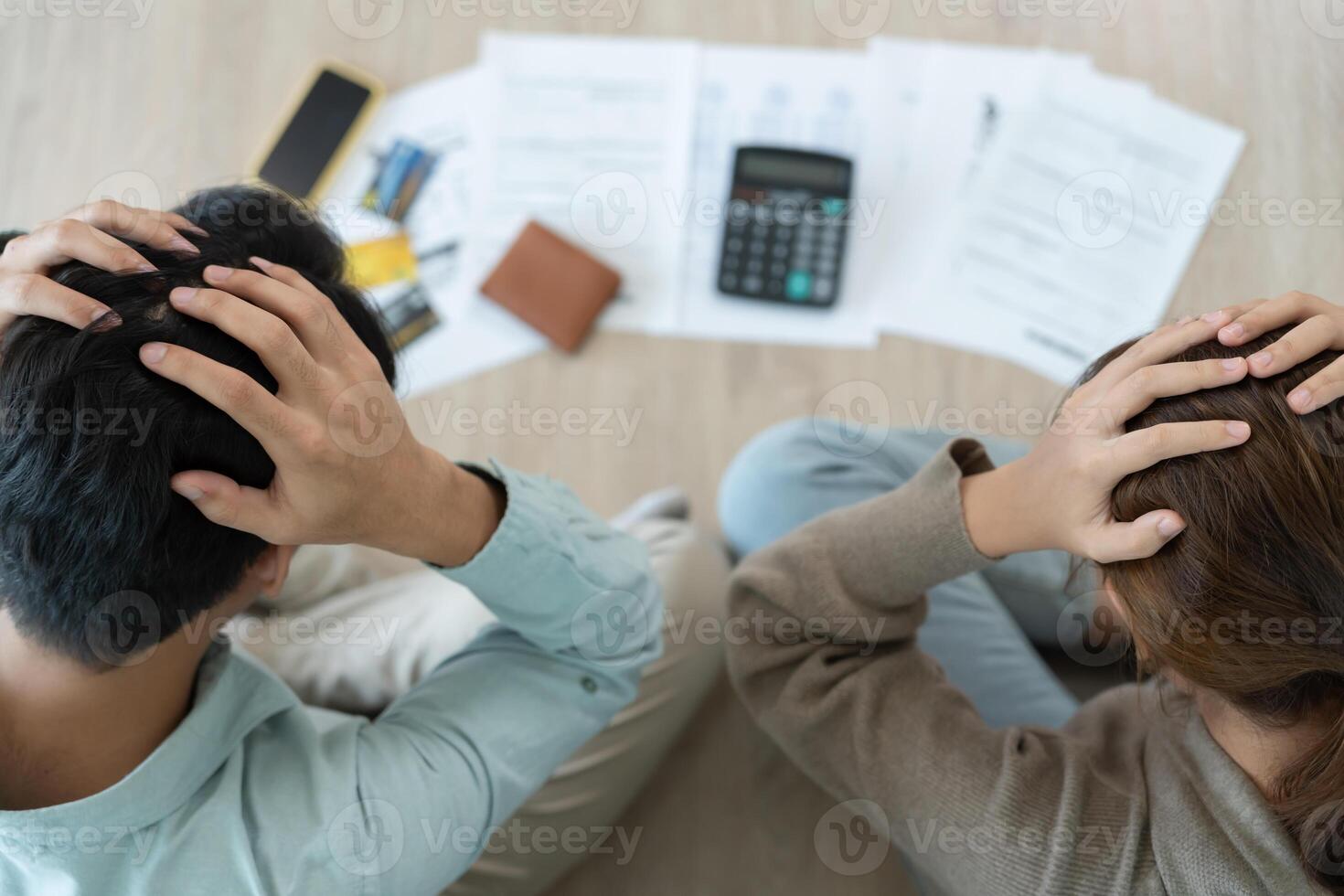 Stressed headache asian couple with large bills or invoices no money to pay to expenses and credit card debt. shortage, Financial problems, mortgage, loan, bankruptcy, bankrupt, poor, empty wallet photo