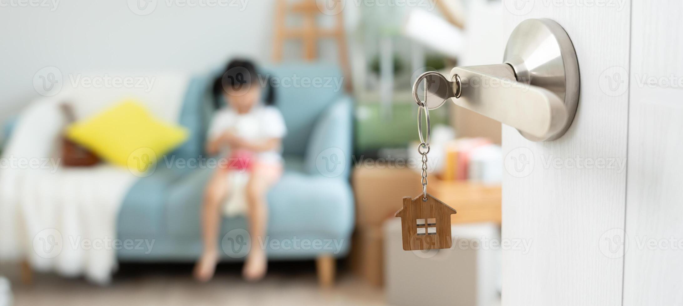 Moving house, relocation. Open the door found daughter play on new house, inside the room was a cardboard box contain personal belongings and furniture. move in the new apartment or home. photo