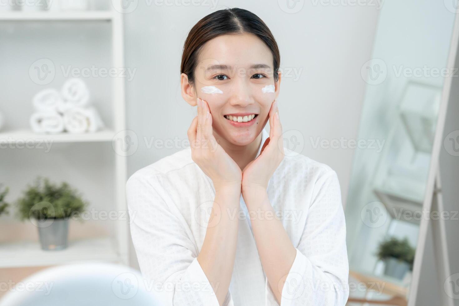 Beautiful Asian woman smile use cream for good skin. face of a healthy woman apply cream and makeup. Advertisement for skin cream, anti-wrinkle, baby face, whitening, tighten pores serum. photo