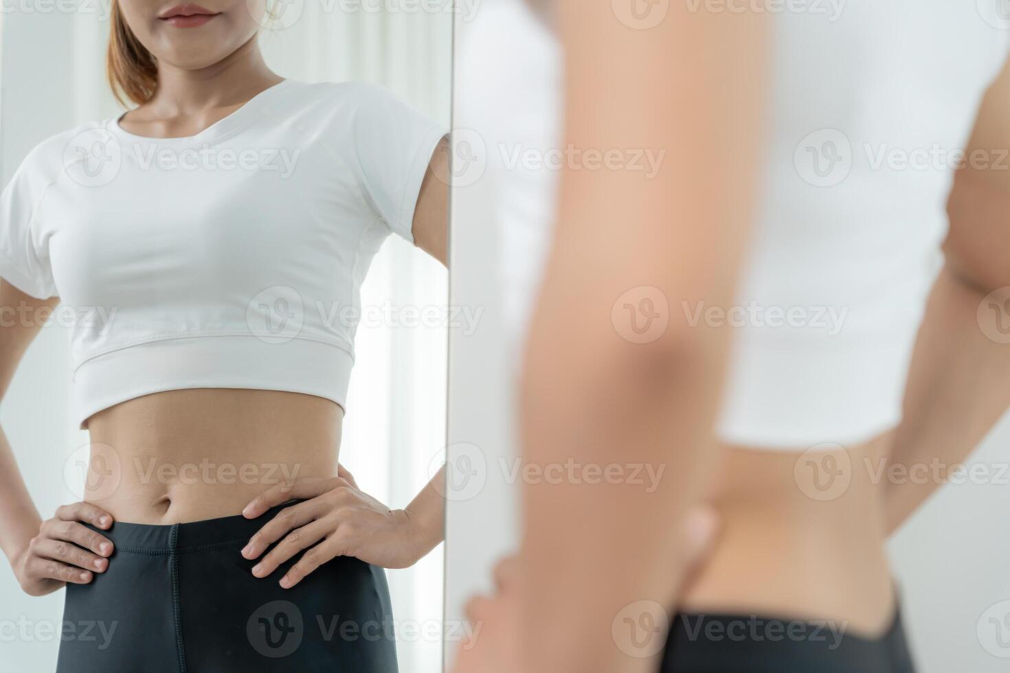 Women showing results diet. Beautiful shape. female look mirror for check shape body have a reduced waist size after under going a weight loss corse. balance, control, routines, exercise. photo