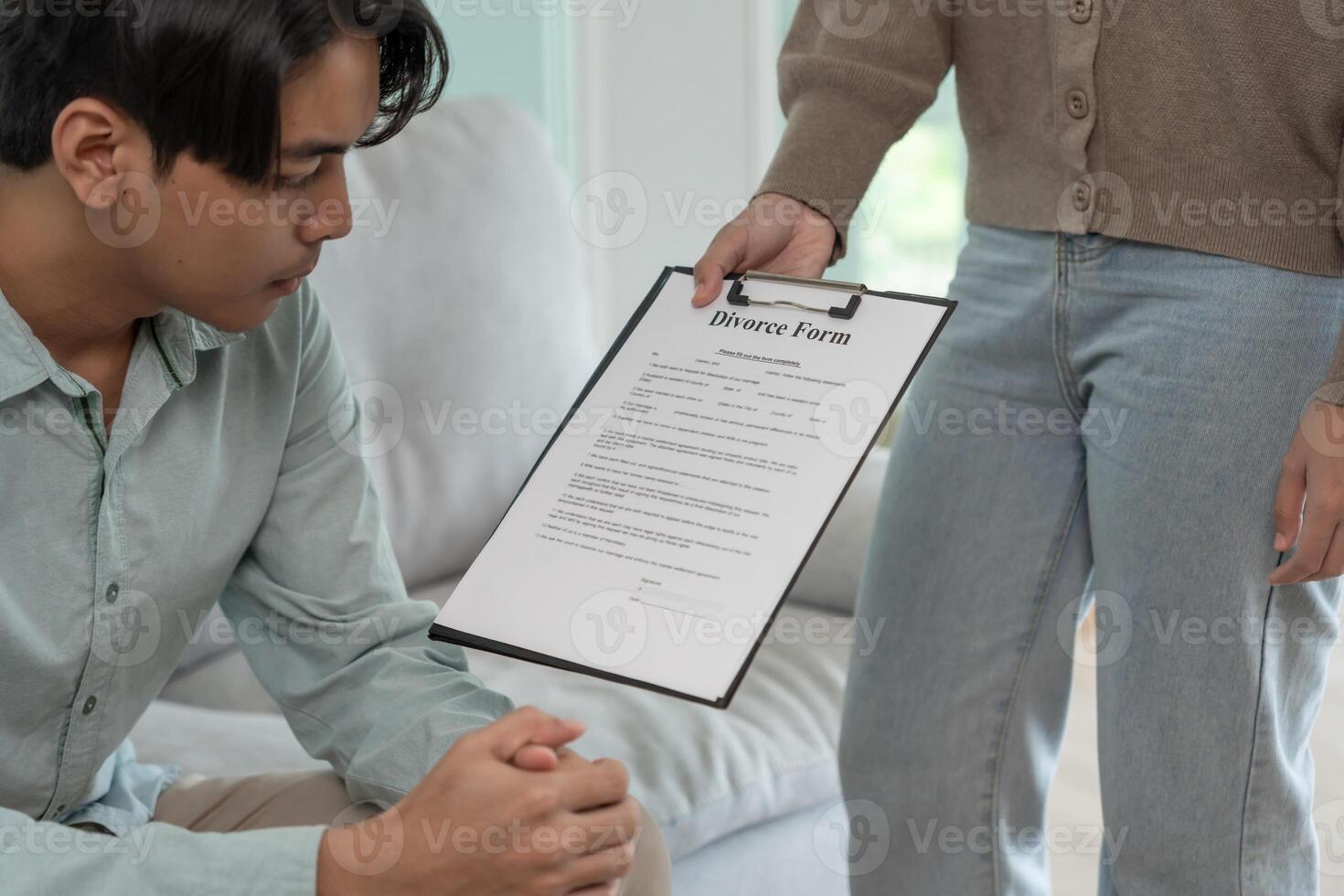 Divorce. Wife pass on Divorce form for husband. Couples desperate and disappointed after marriage. wife sad, upset and frustrated after quarrels conflict. distrust, love problems photo