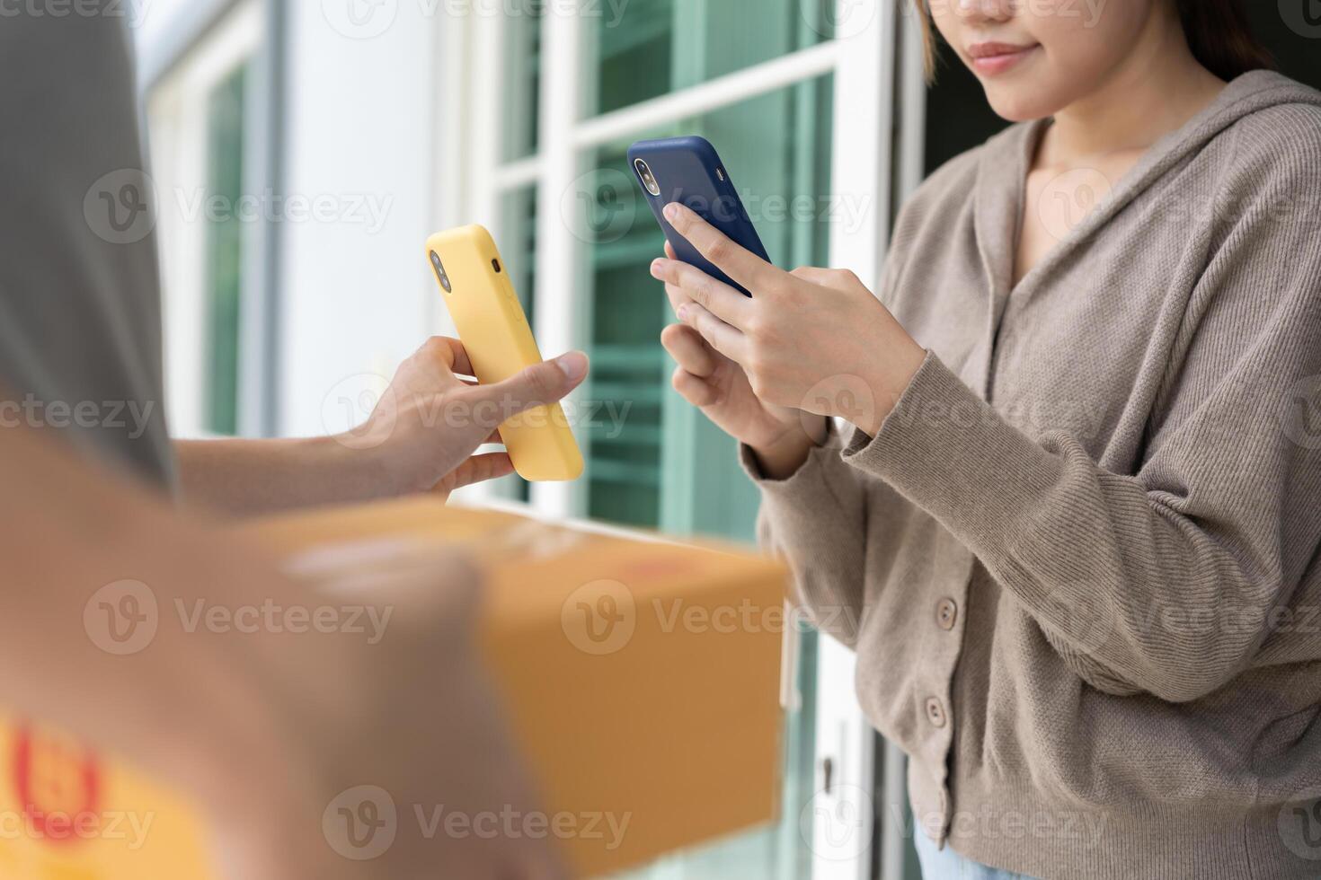 Happy smile Asian woman scan QR code for pay of food. Delivery man send deliver express. online shop, paper container, takeaway, postman, delivery service, packages, electronic money. photo